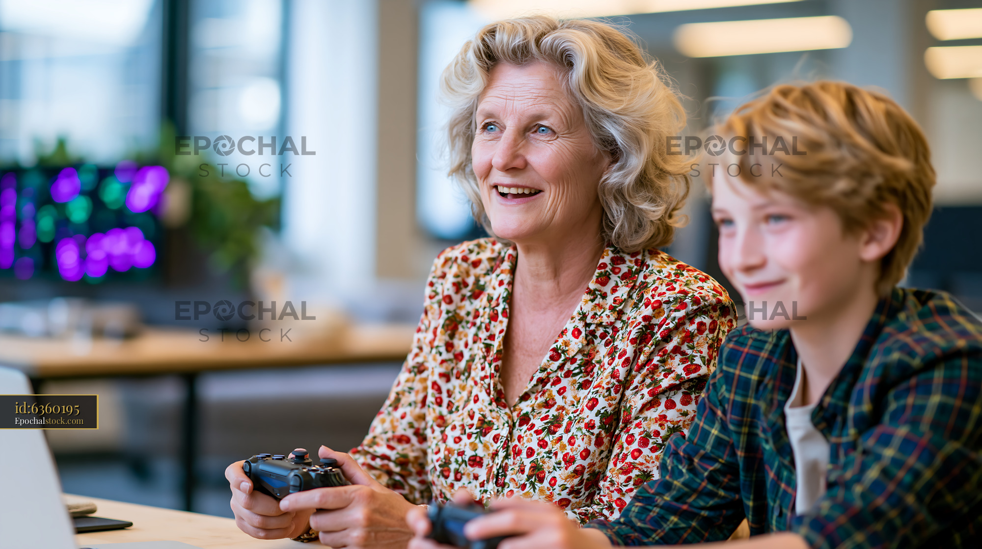 Watermarked full-resolution preview of Grandmother and grandson playing video games together