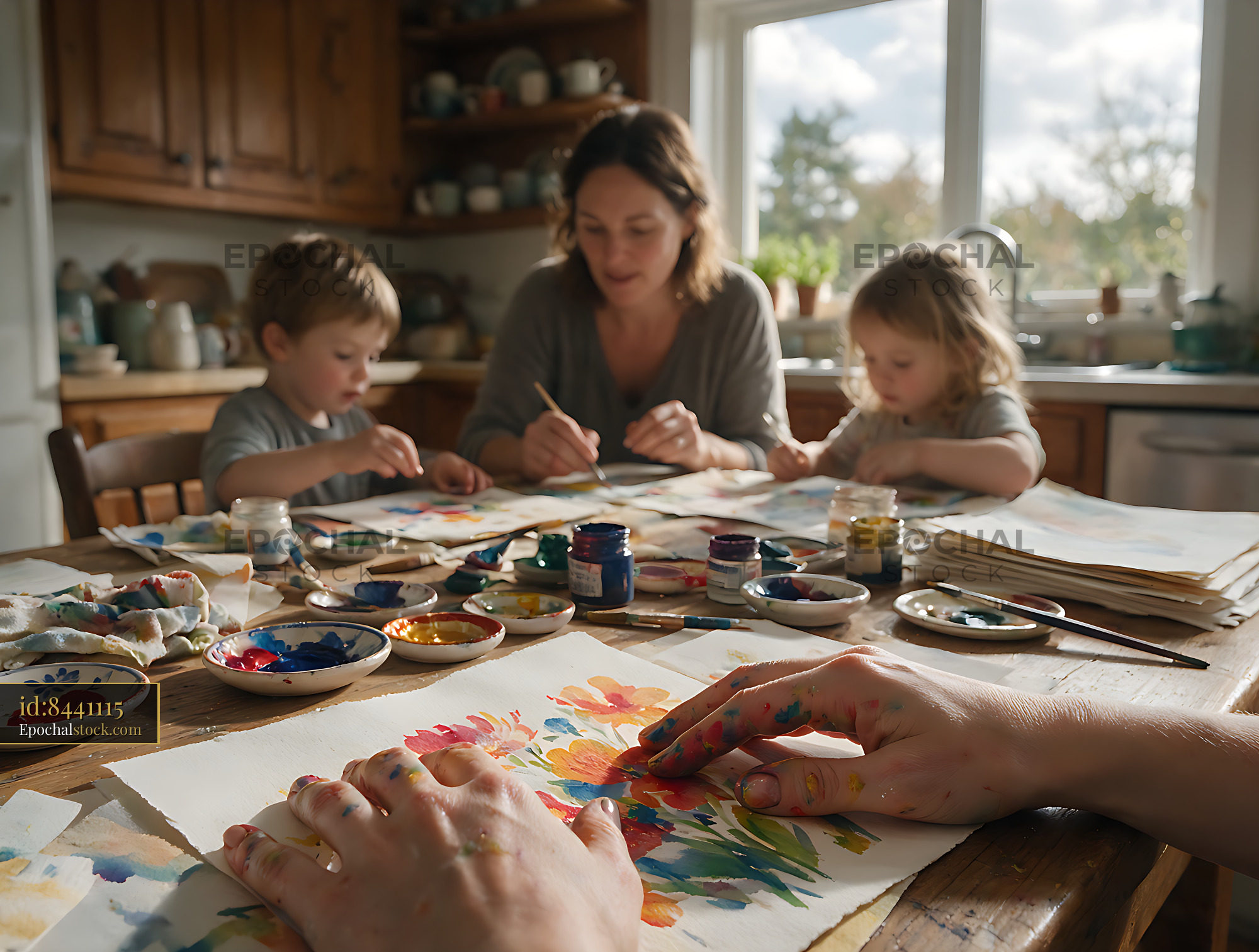 Watermarked full-resolution preview of Family painting activity around a kitchen table