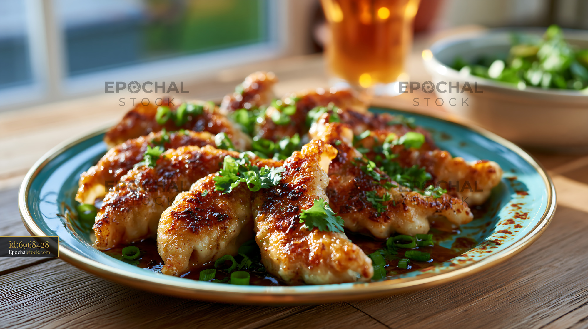 Watermarked full-resolution preview of Grilled chicken wings served with green onions