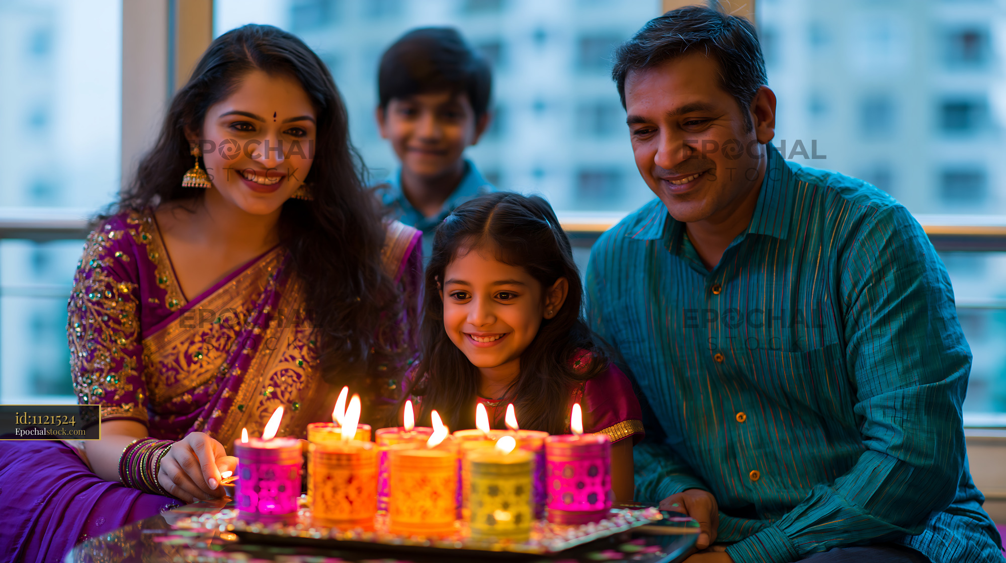 Watermarked full-resolution preview of Family celebration with candles during festival at home