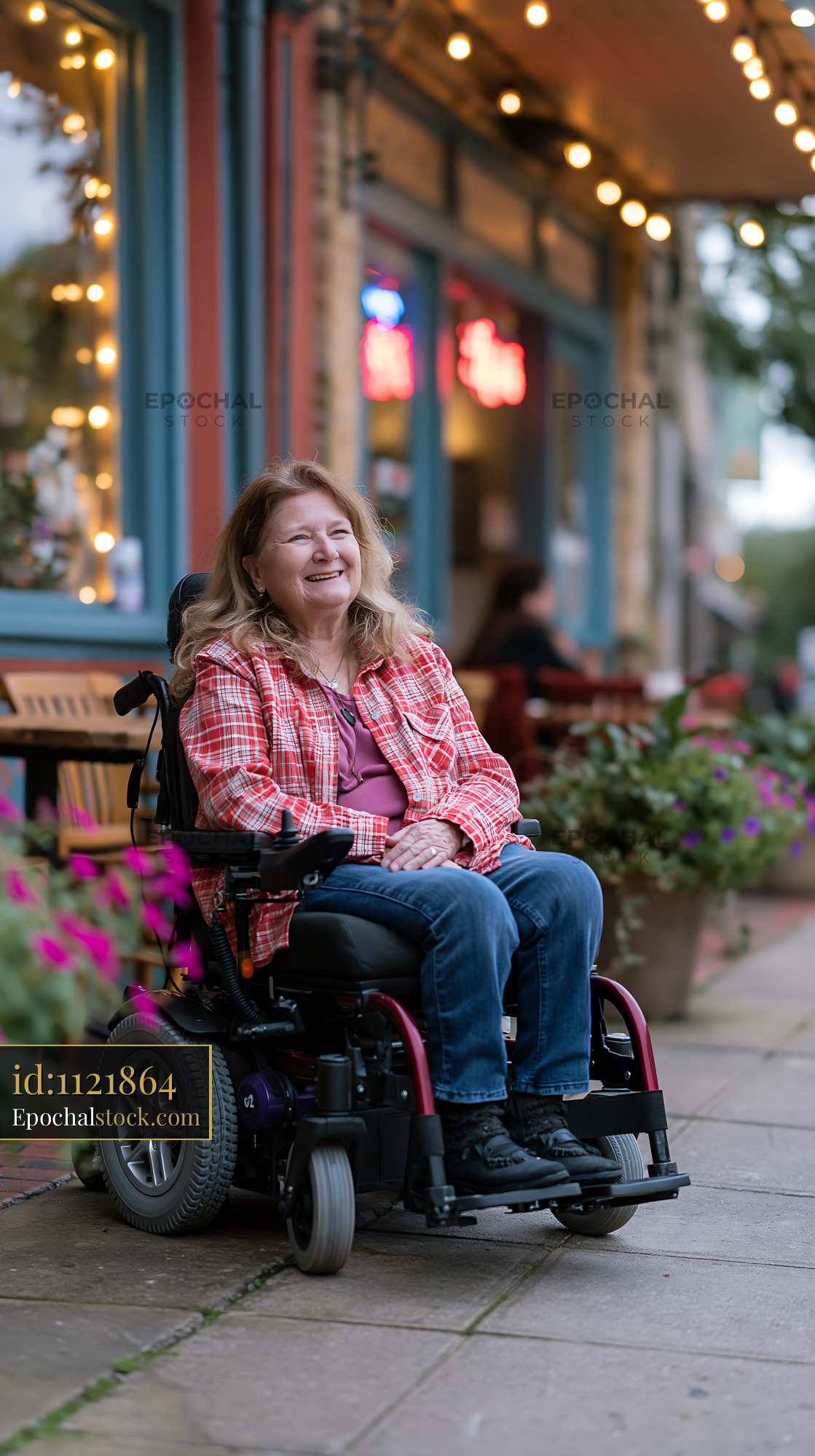 Watermarked full-resolution preview of Woman in wheelchair enjoys time outside a cafe with flowers