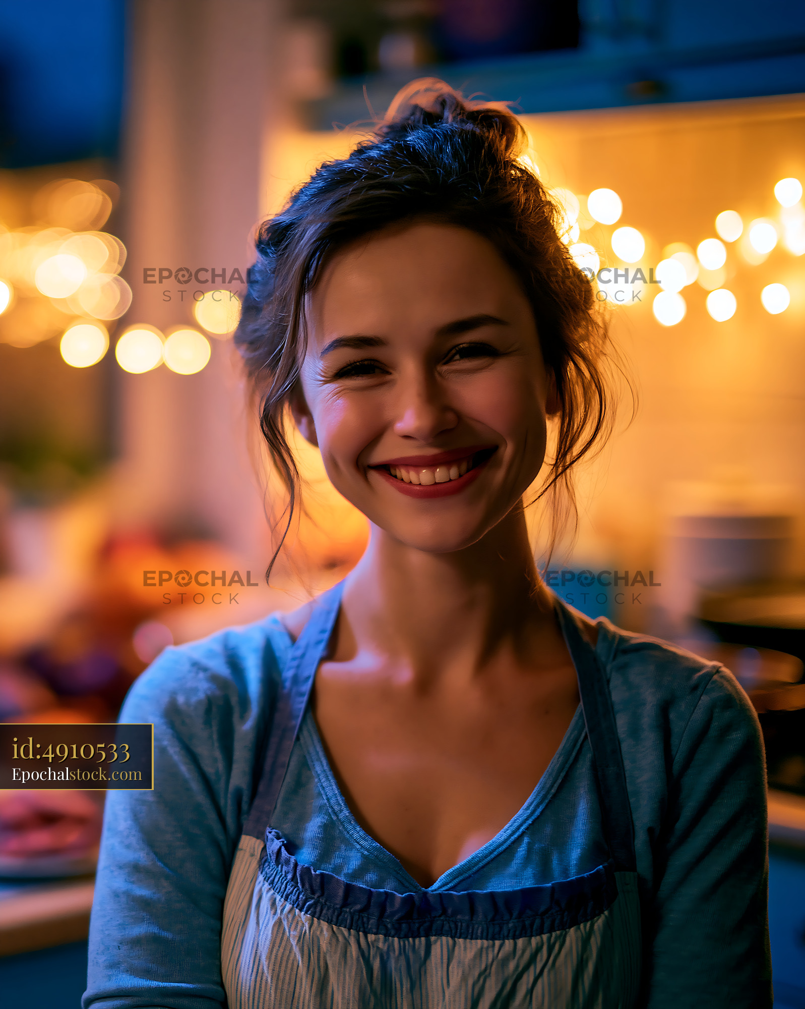 Watermarked full-resolution preview of Woman smiling in kitchen with warm light and holiday decorations