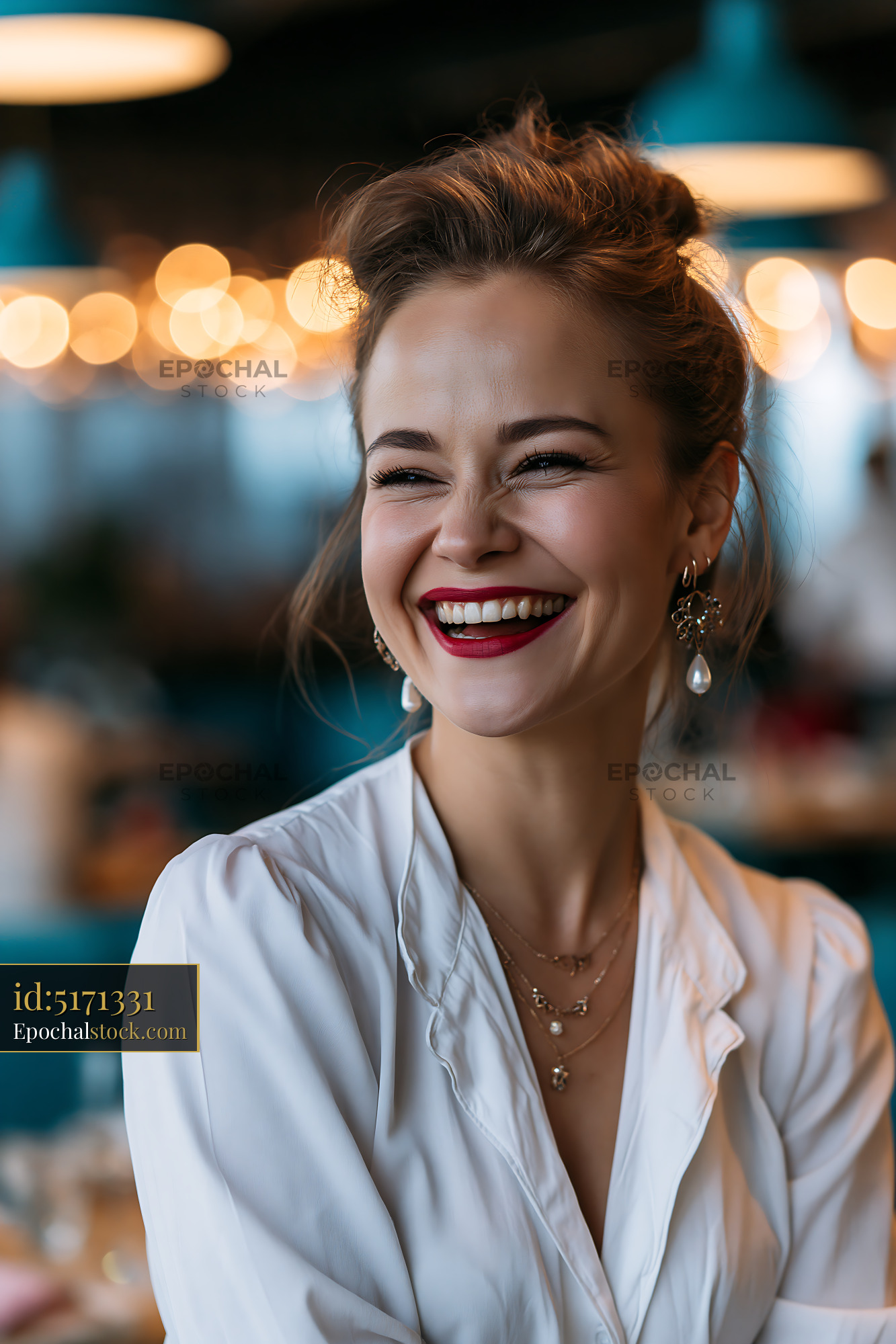 Watermarked full-resolution preview of Woman smiling in a restaurant with a warm atmosphere