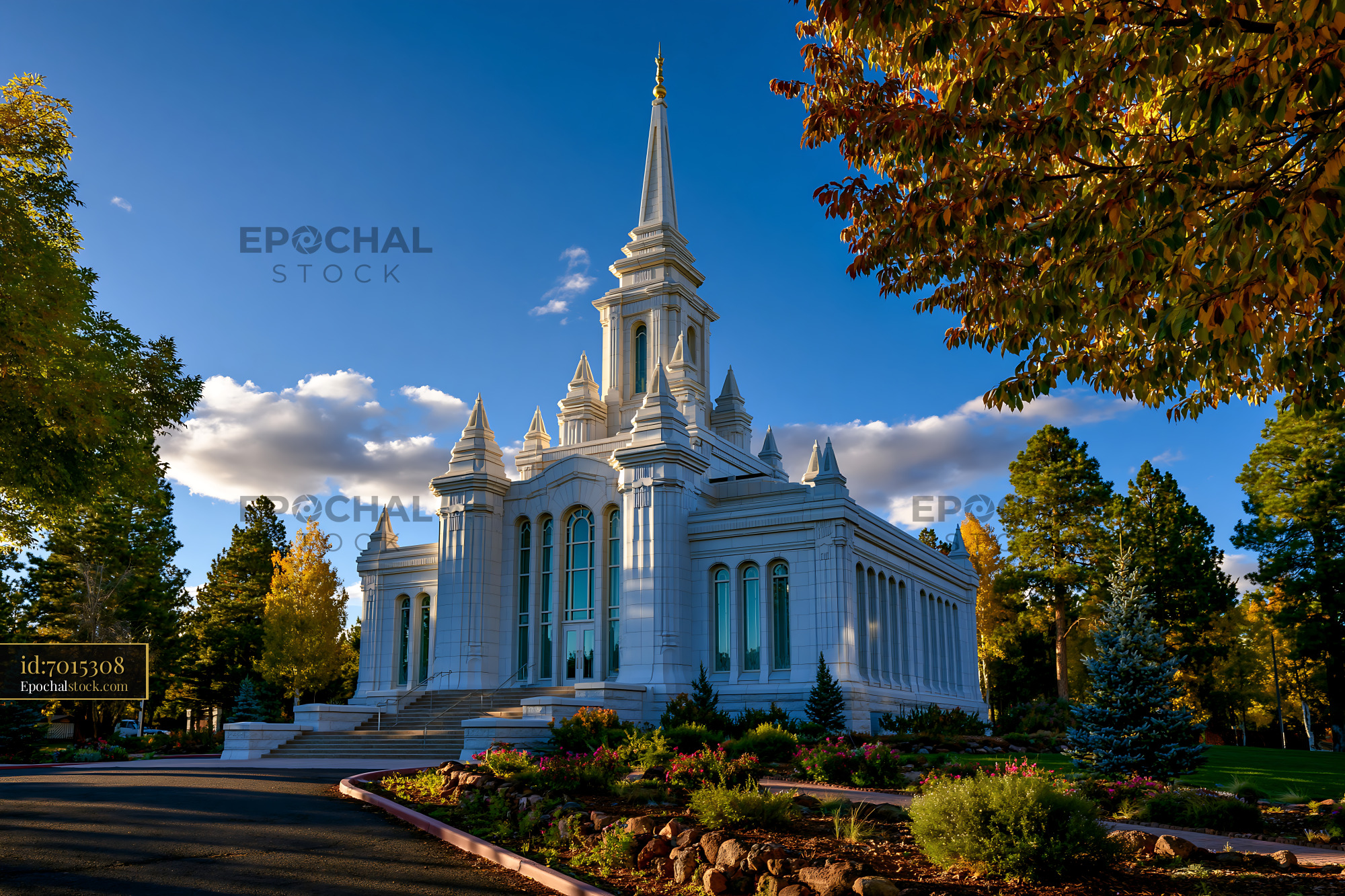 Watermarked full-resolution preview of White church building with tall spire and trees in the background