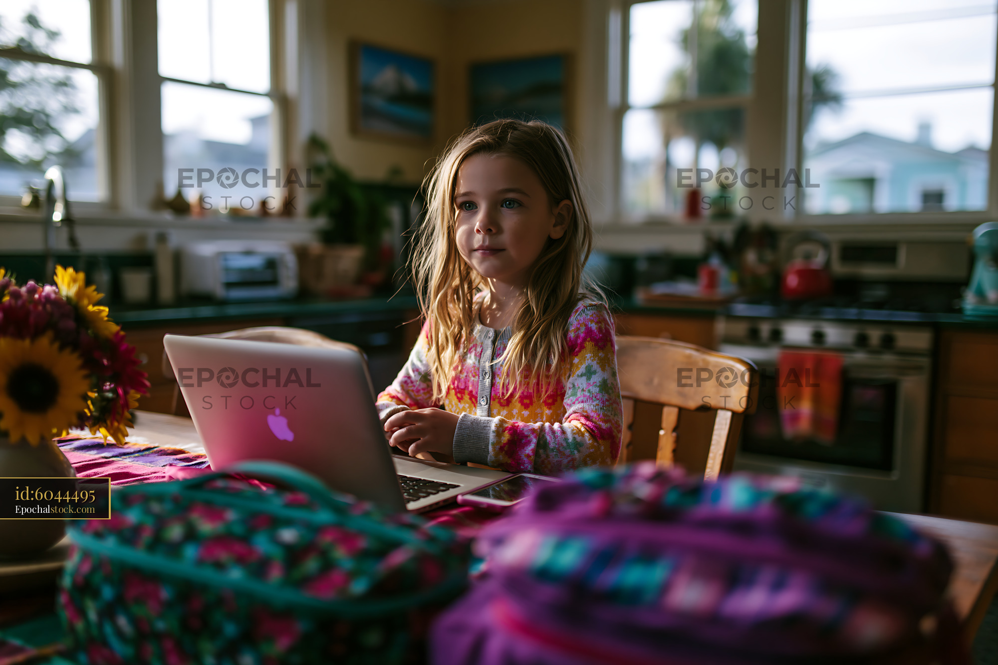 Child Using Laptop at Home With Packed Bags and Flowers — stock example for home hero and product mood