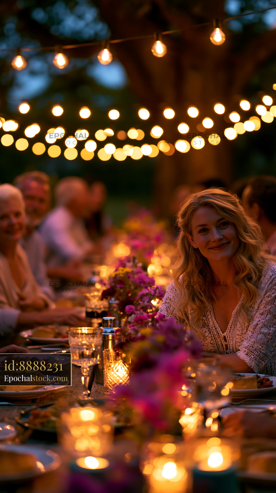 Watermarked full-resolution preview of Gathering around the table at a festive outdoor dinner event