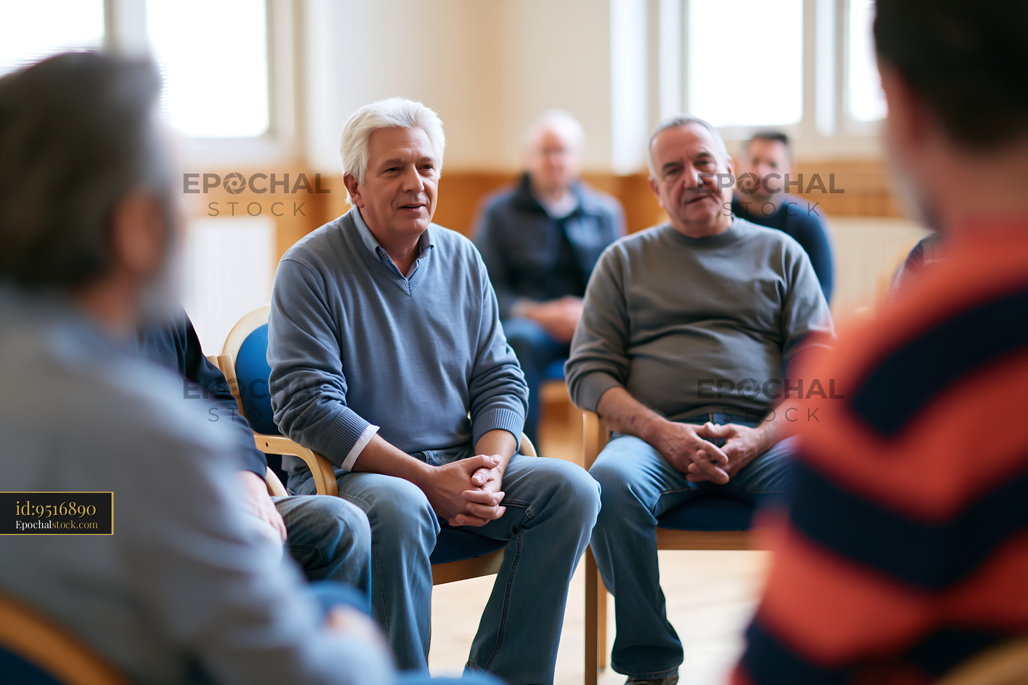 Watermarked full-resolution preview of Older men participating in an indoor group discussion