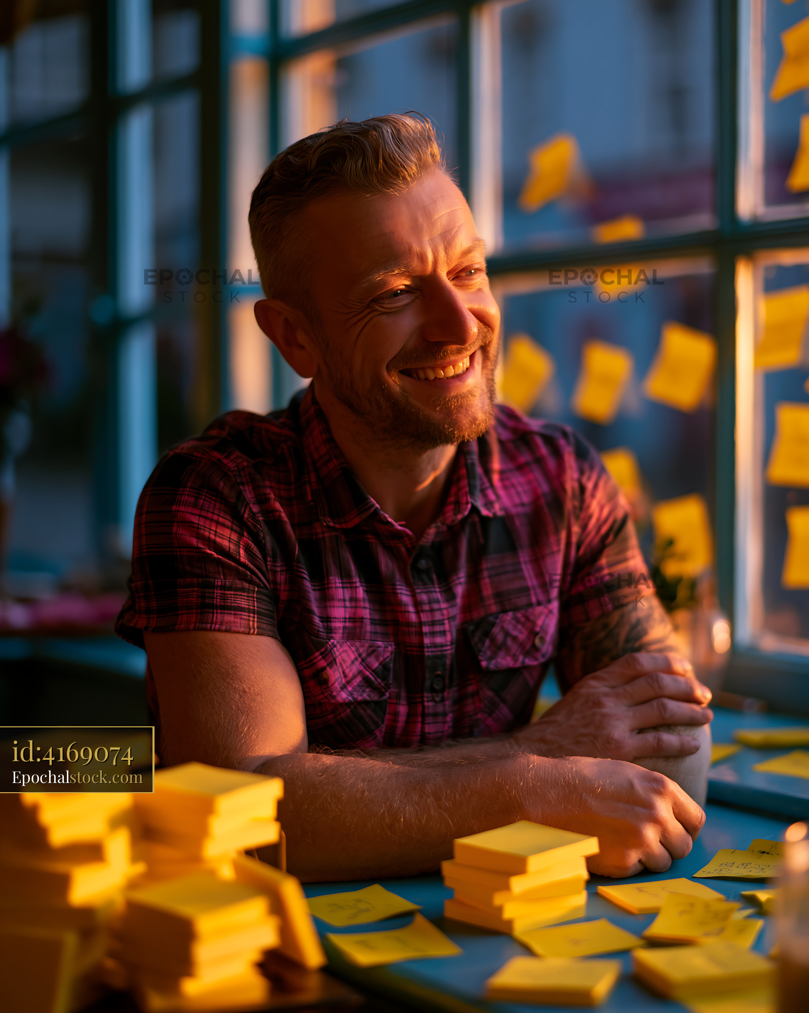 Watermarked full-resolution preview of Man sitting by a window with sticky notes in a cafe