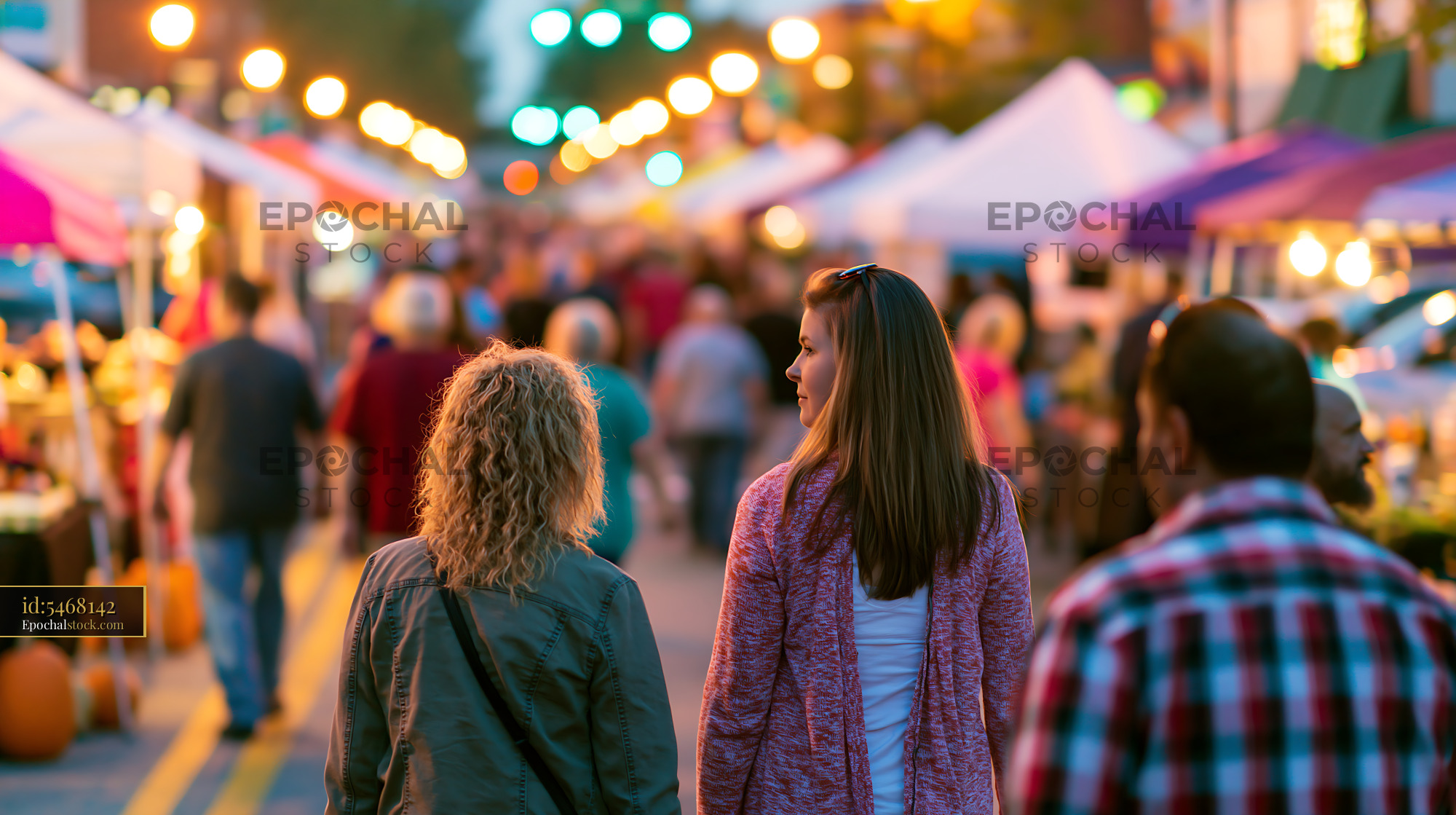 Neighbors at a Local Harvest Festival Walking Through the Street - stock photo