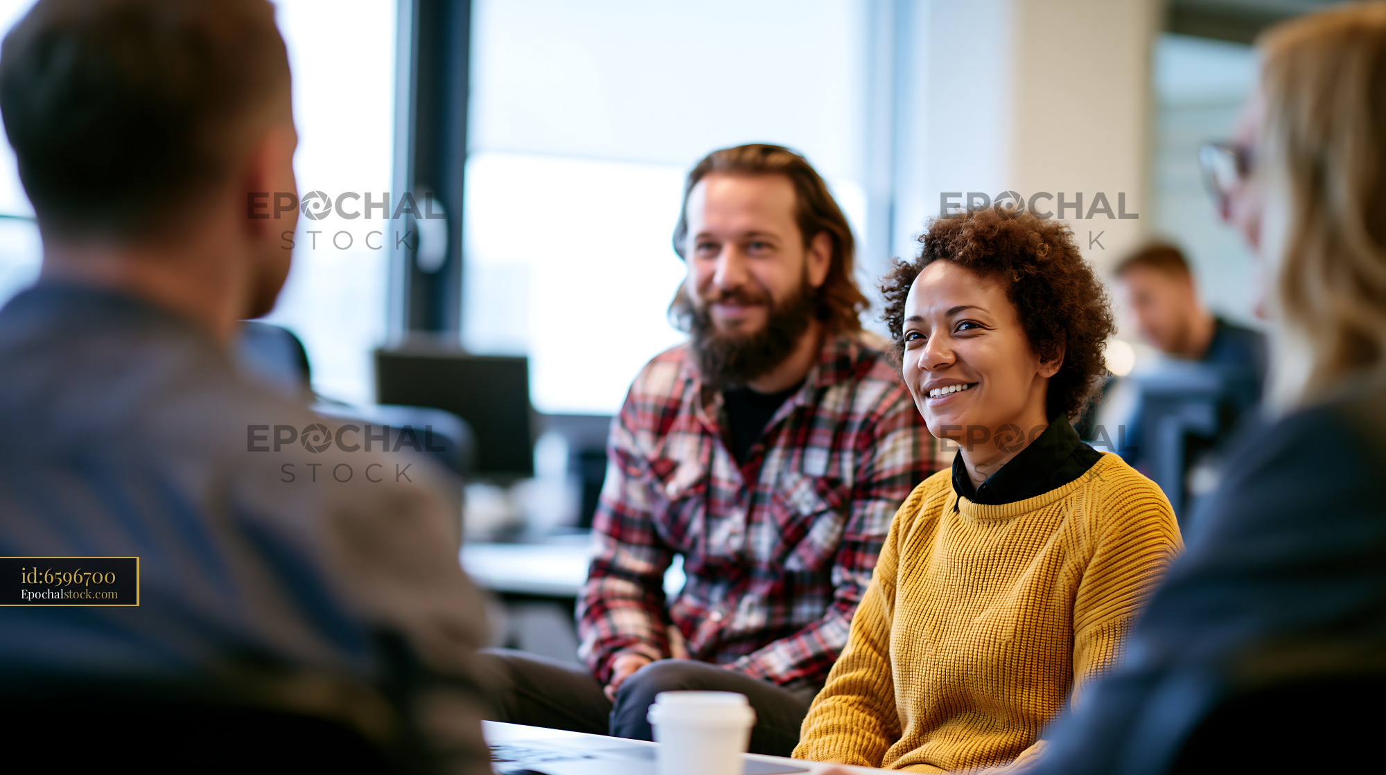 Watermarked full-resolution preview of People engaging in discussion during a meeting in an office