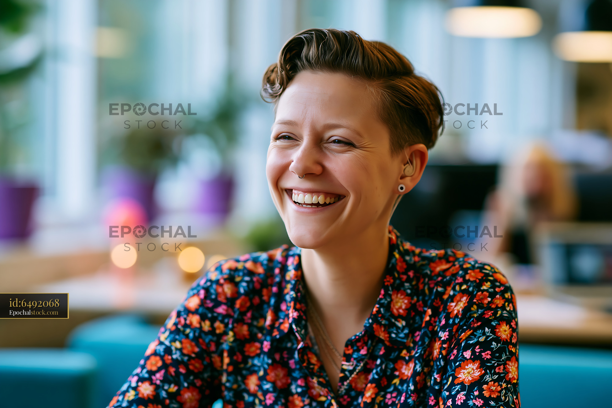Watermarked full-resolution preview of Woman smiling in a vibrant cafe setting with colorful decor