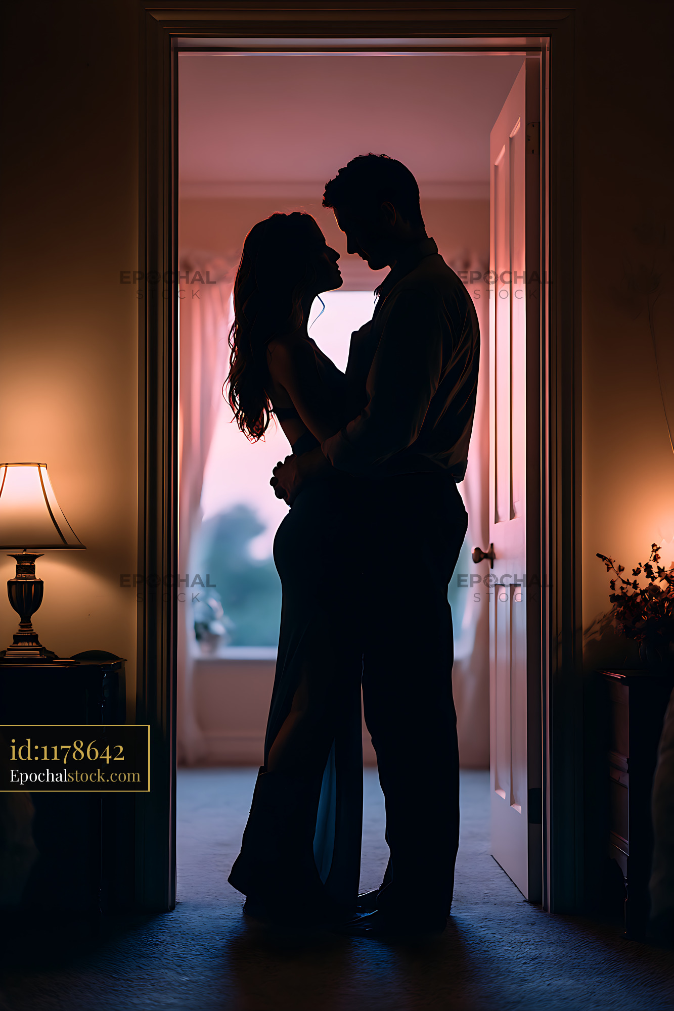 Watermarked full-resolution preview of Romantic couple embracing in an open doorway