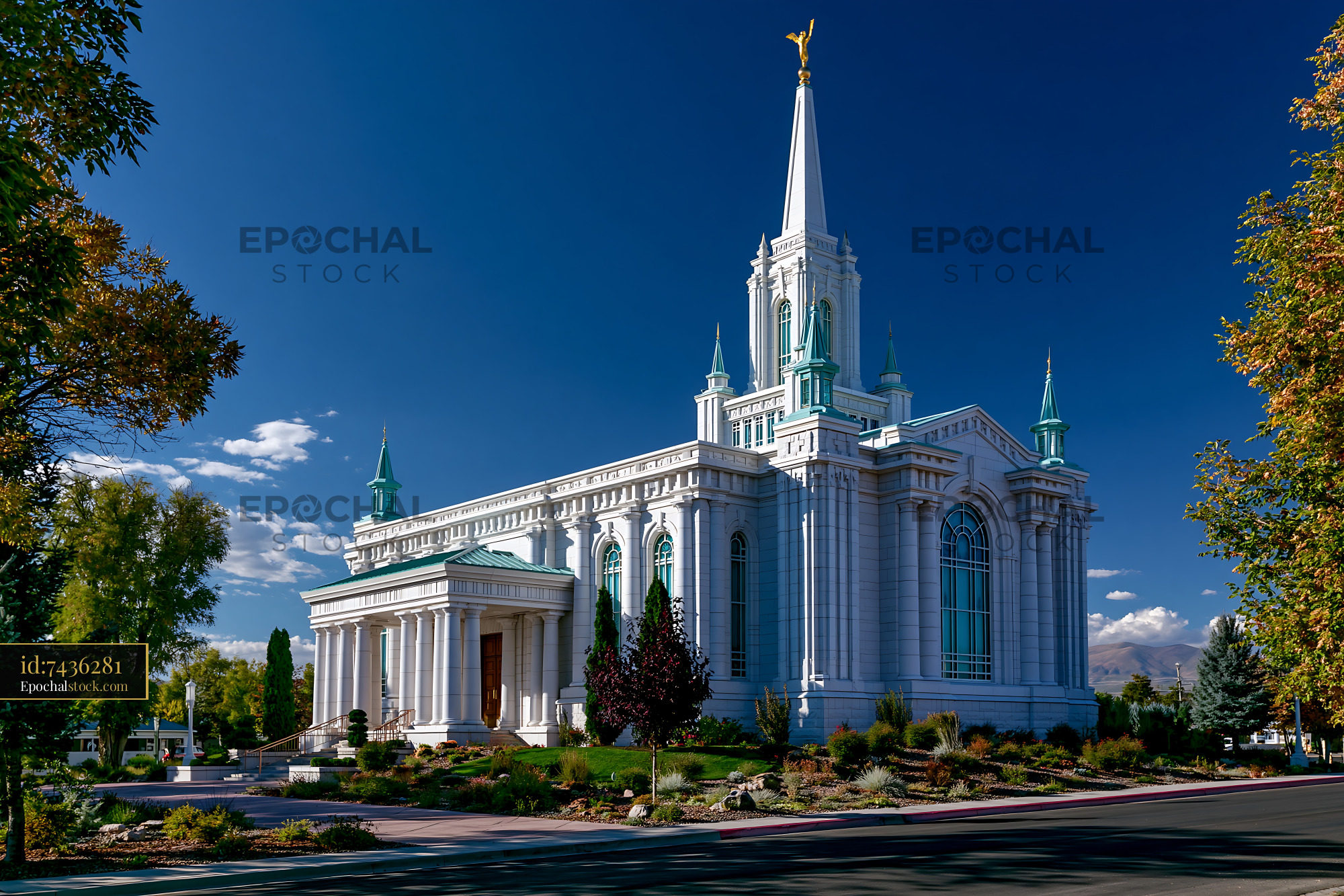 Watermarked full-resolution preview of White modern church building with spire against blue sky