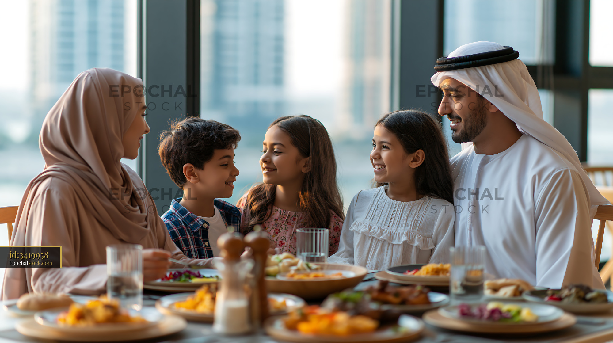 Family Sharing Iftar Dinner by the Window in a City Setting - stock photo
