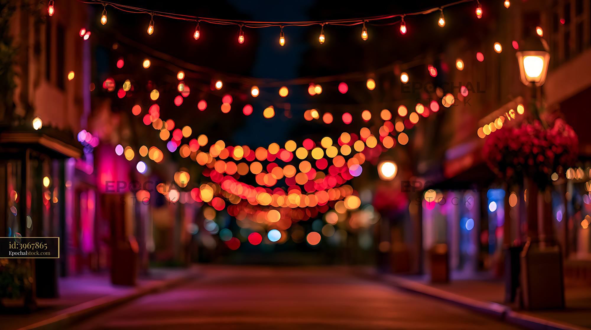Watermarked full-resolution preview of Colorful bokeh string lights on an illuminated urban street