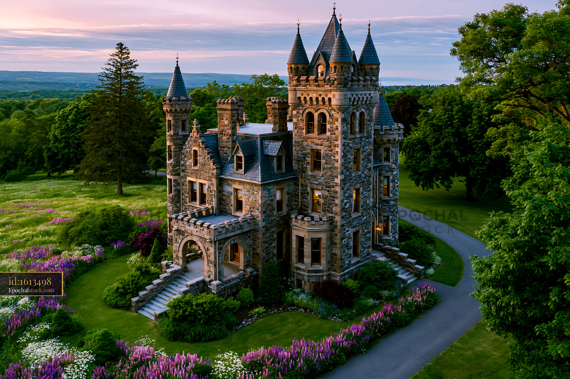 Watermarked full-resolution preview of Historic stone castle surrounded by colorful flowers and trees