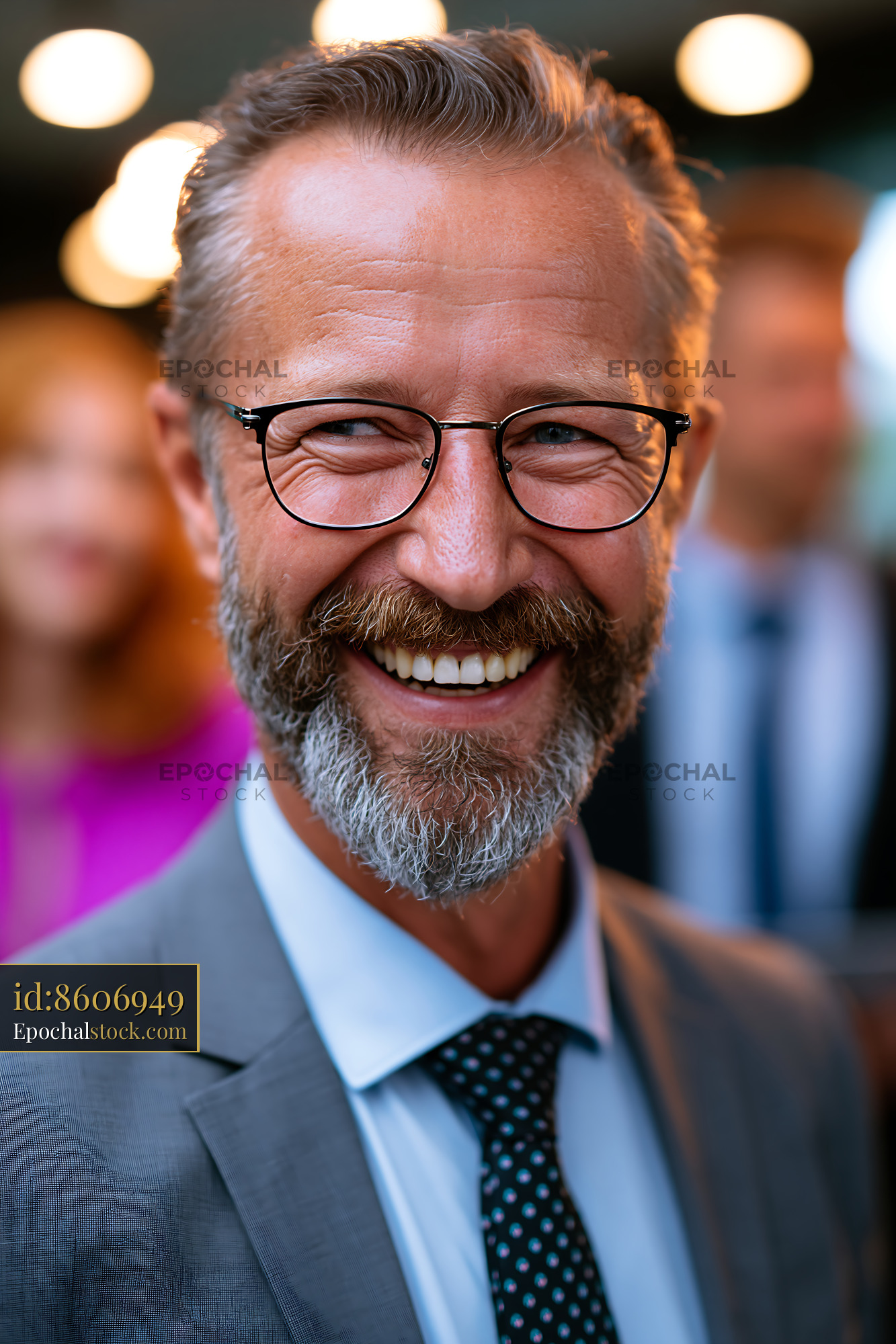 Watermarked full-resolution preview of Man smiling at outdoor event with blurred crowd behind