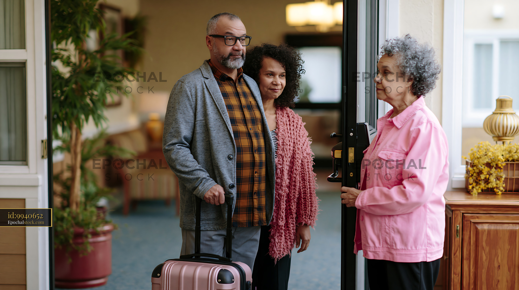Watermarked full-resolution preview of Family reunion at the door with suitcase and warm greetings