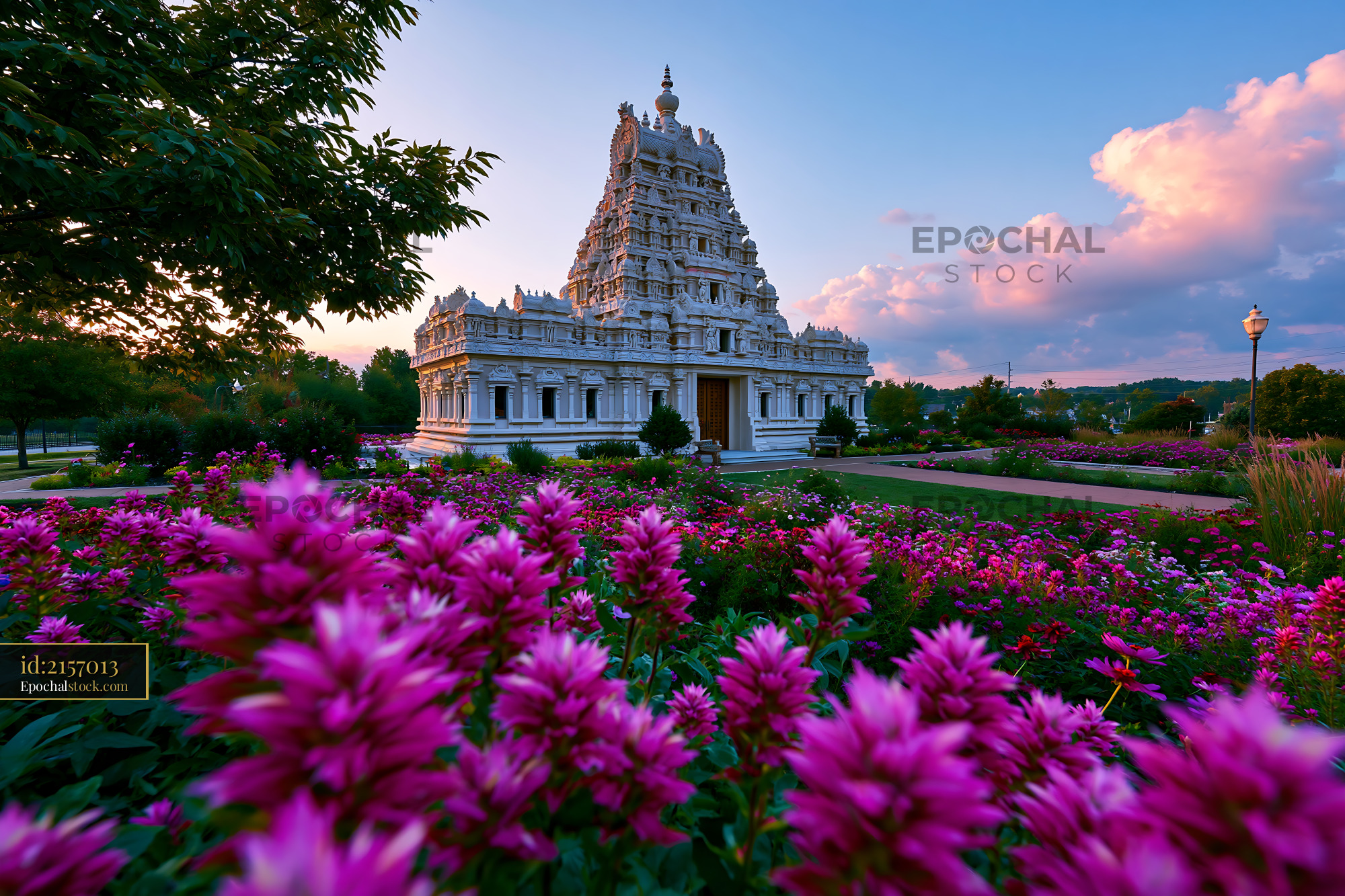 Watermarked full-resolution preview of White ornate temple in a vibrant flower garden