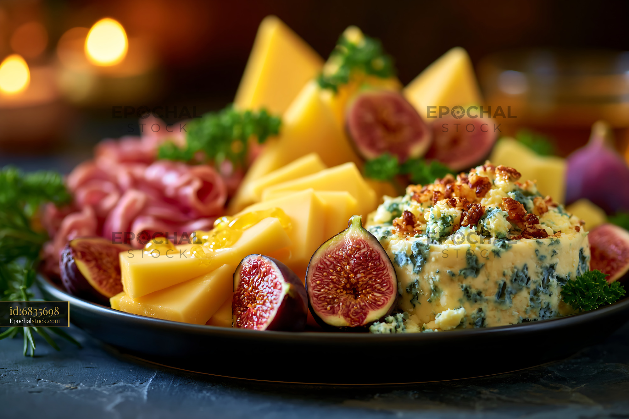 Watermarked full-resolution preview of Gourmet cheese platter with figs, meats, and herbs