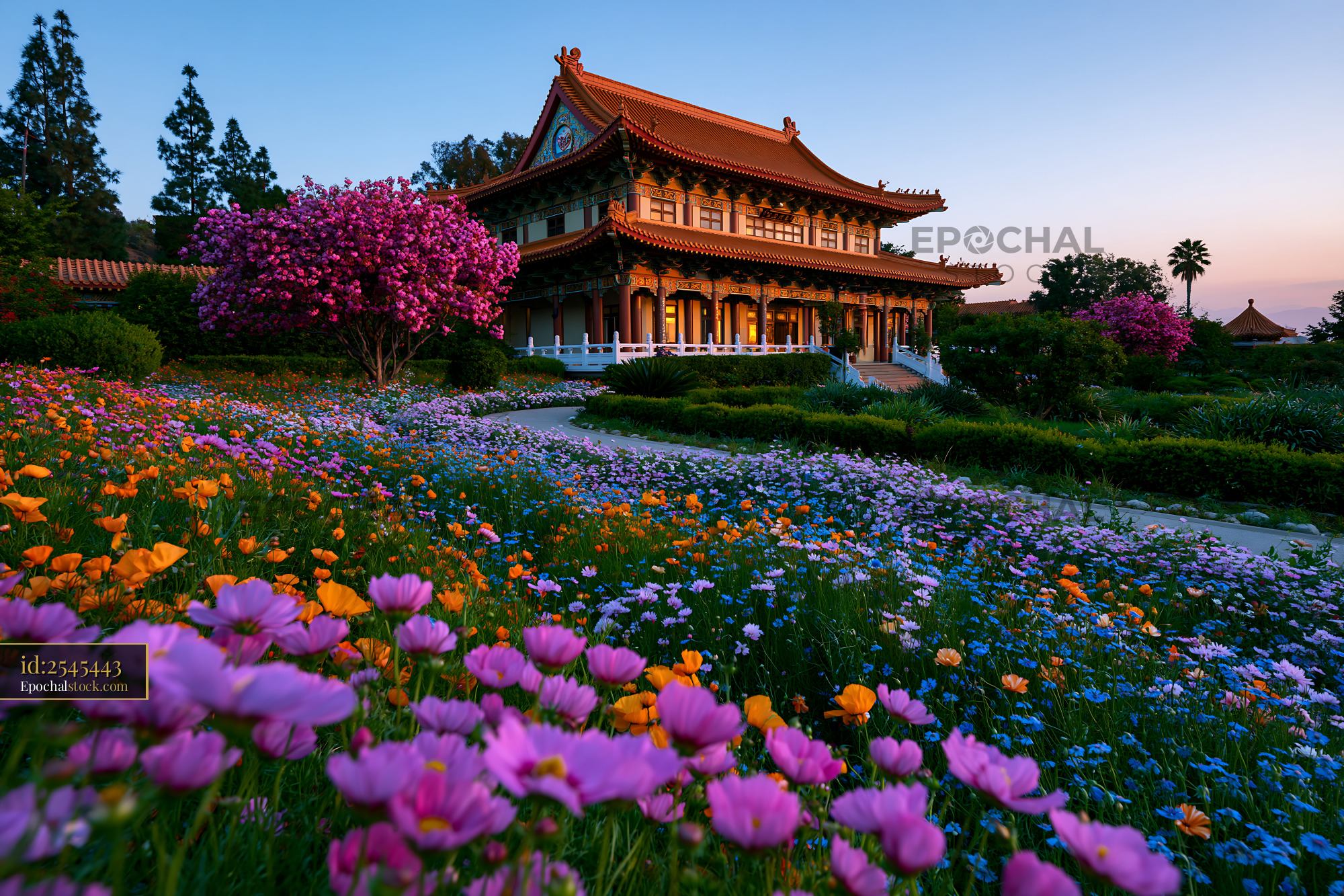 Watermarked full-resolution preview of Colorful flowers surround a traditional building at sunset