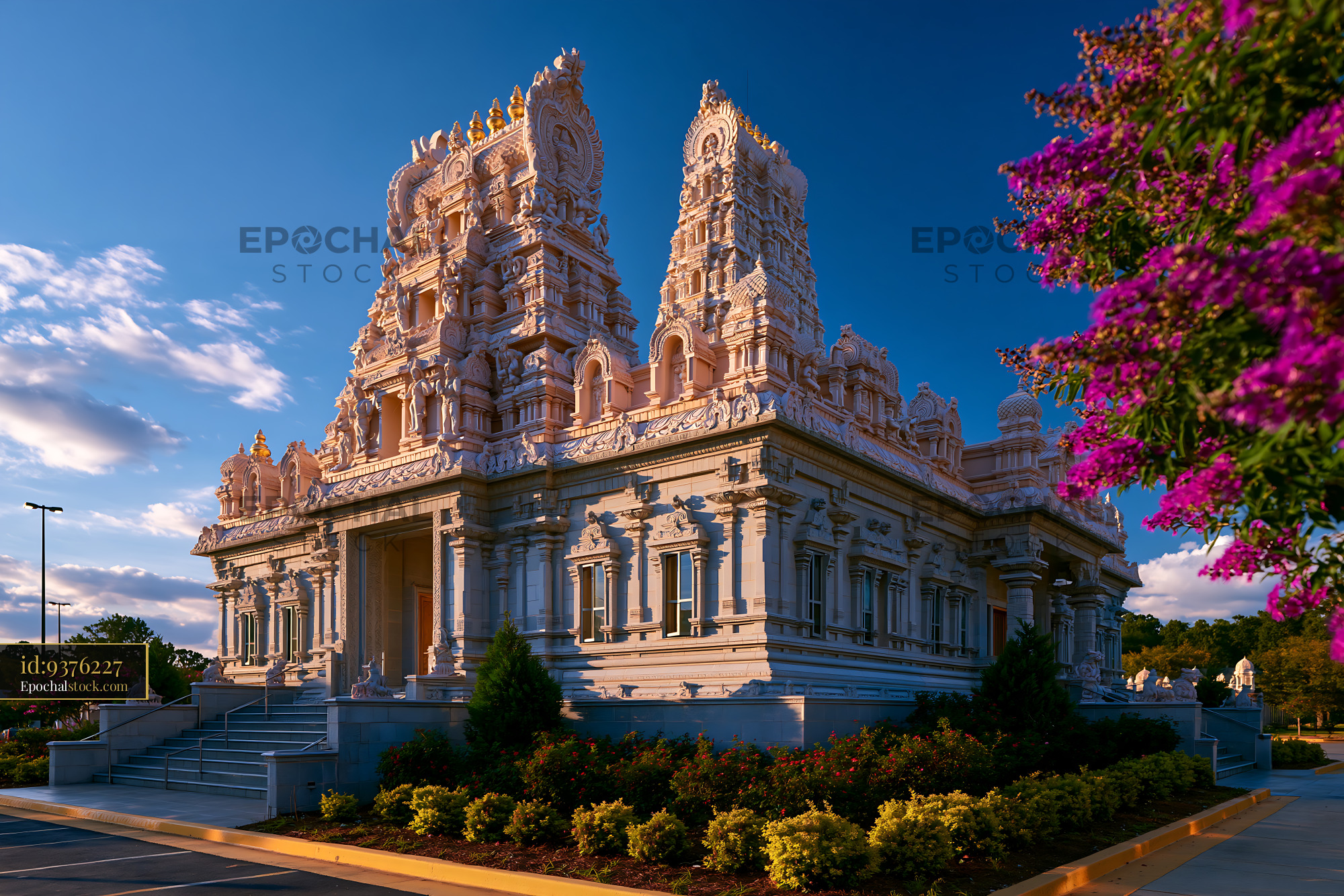 Watermarked full-resolution preview of Hindu temple with detailed architecture and surrounding flowers