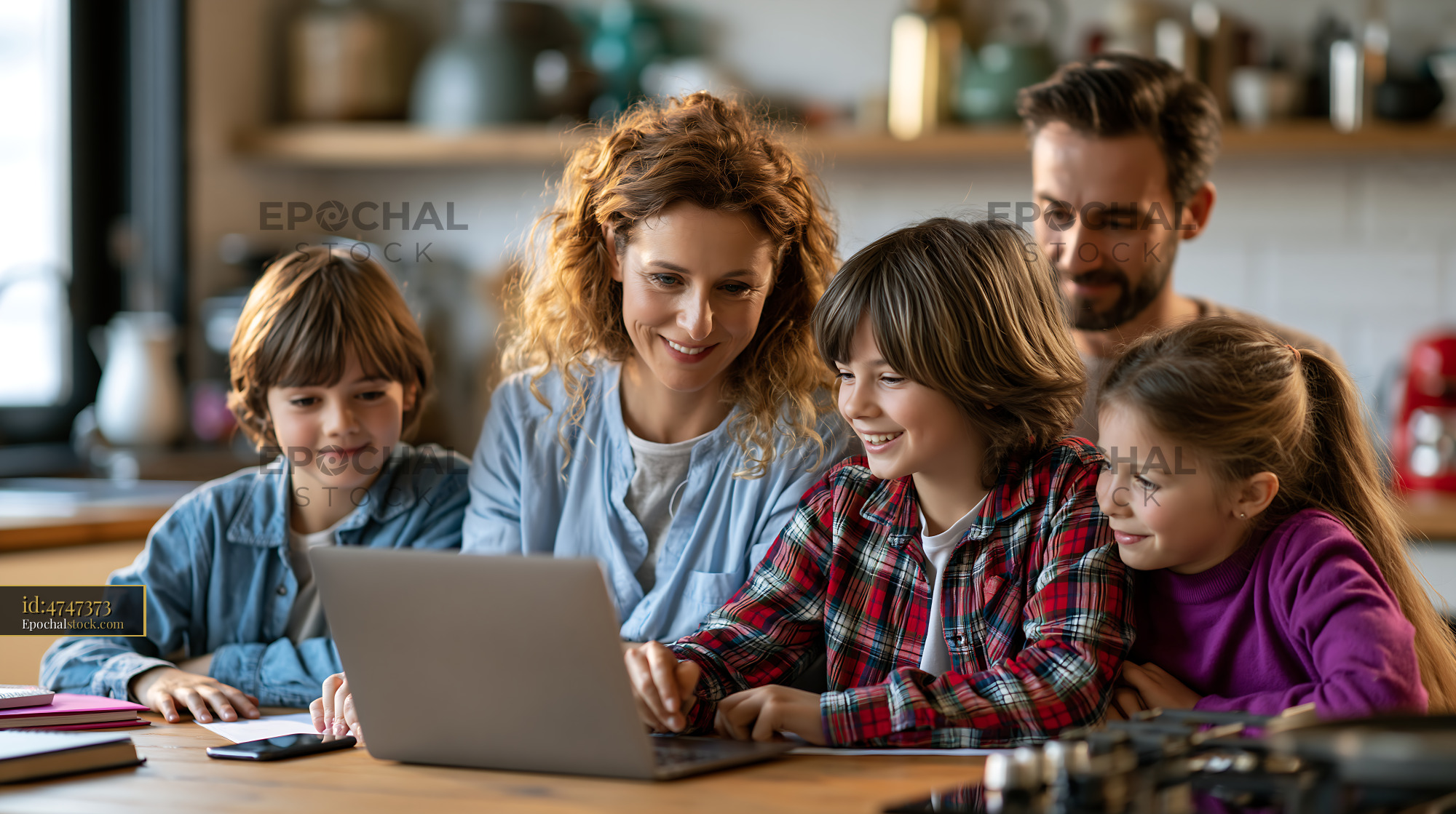 Watermarked full-resolution preview of Family engages with laptop at home in a kitchen setting