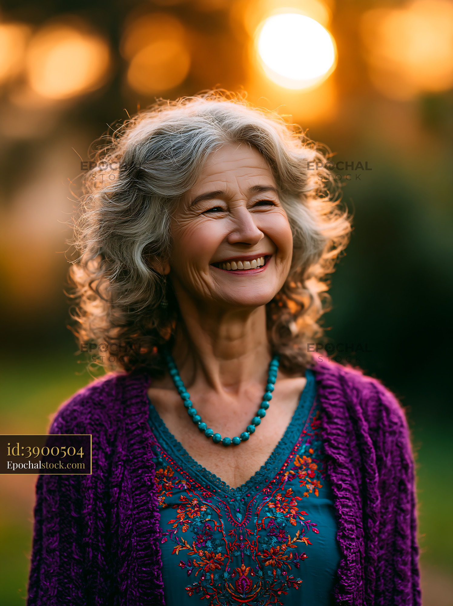 Older Woman Laughing Brightly in Garden During Golden Hour - stock photo