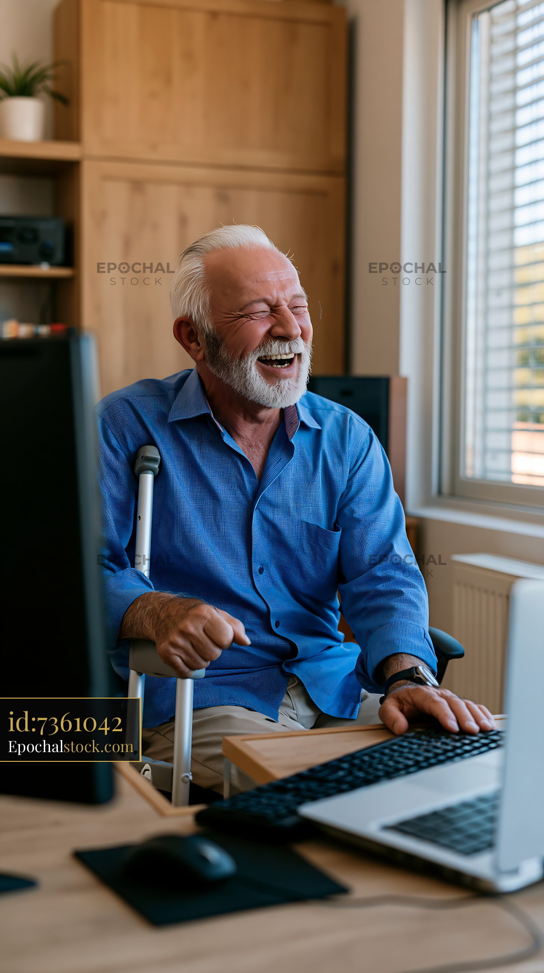 Watermarked full-resolution preview of Senior man using computer at home office with warm smile