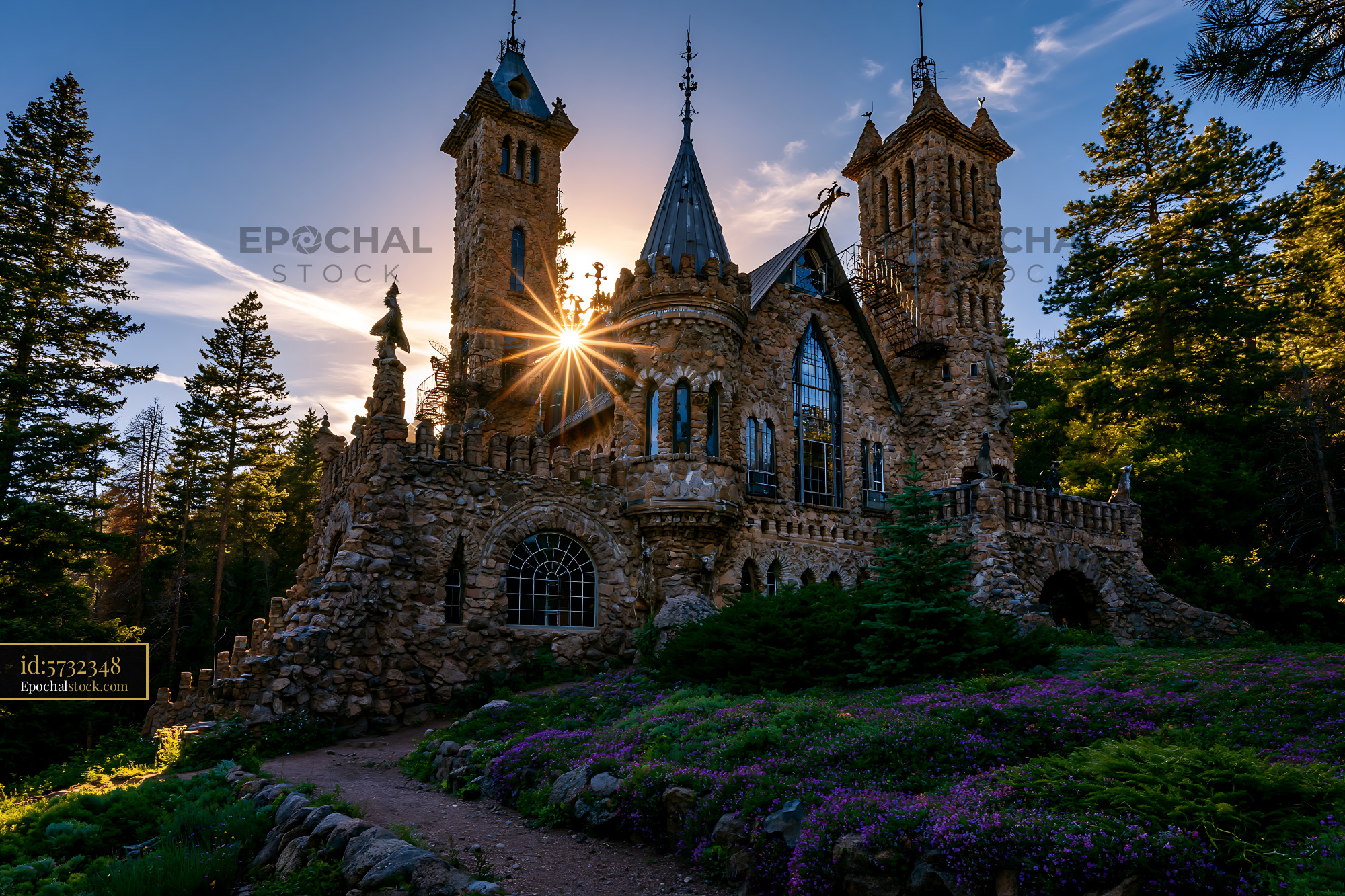 Bisho Castle During Sunset With Surrounding Trees and Flowers - stock photo