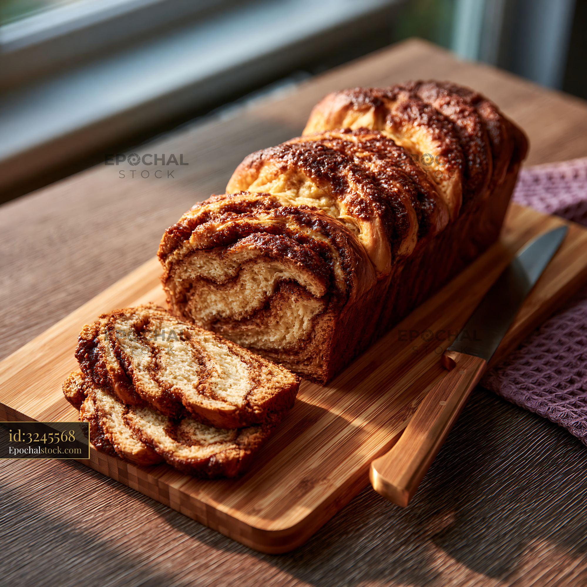 Watermarked full-resolution preview of Freshly sliced bread on a wooden cutting board by a window