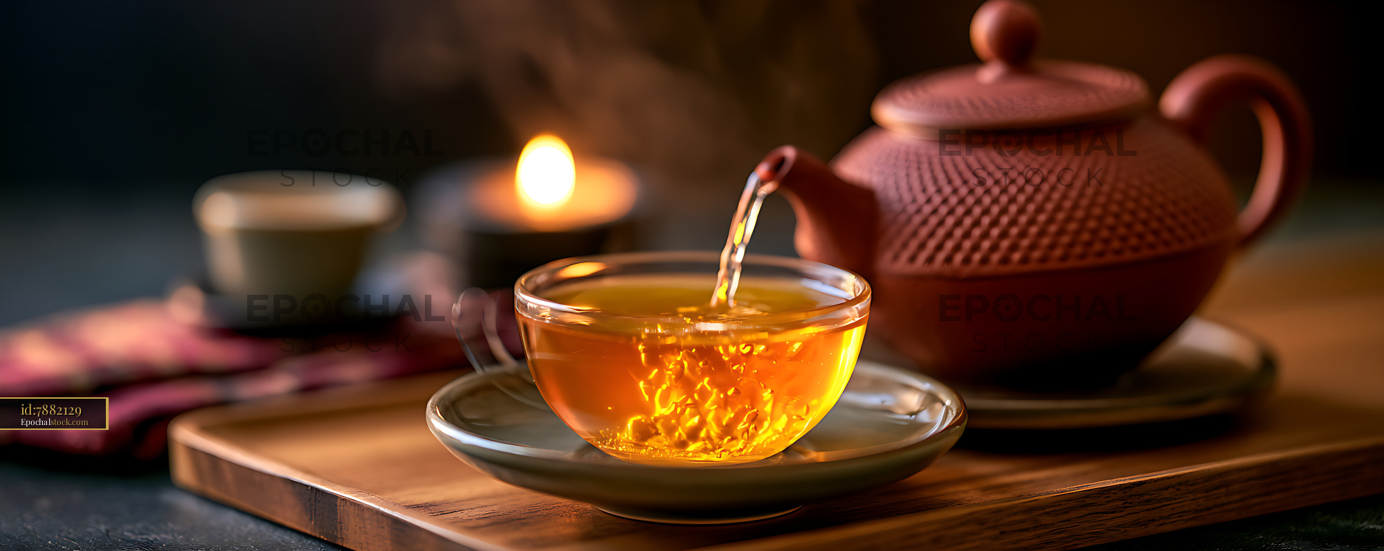 Watermarked full-resolution preview of Warm tea pouring into a glass cup beside a teapot