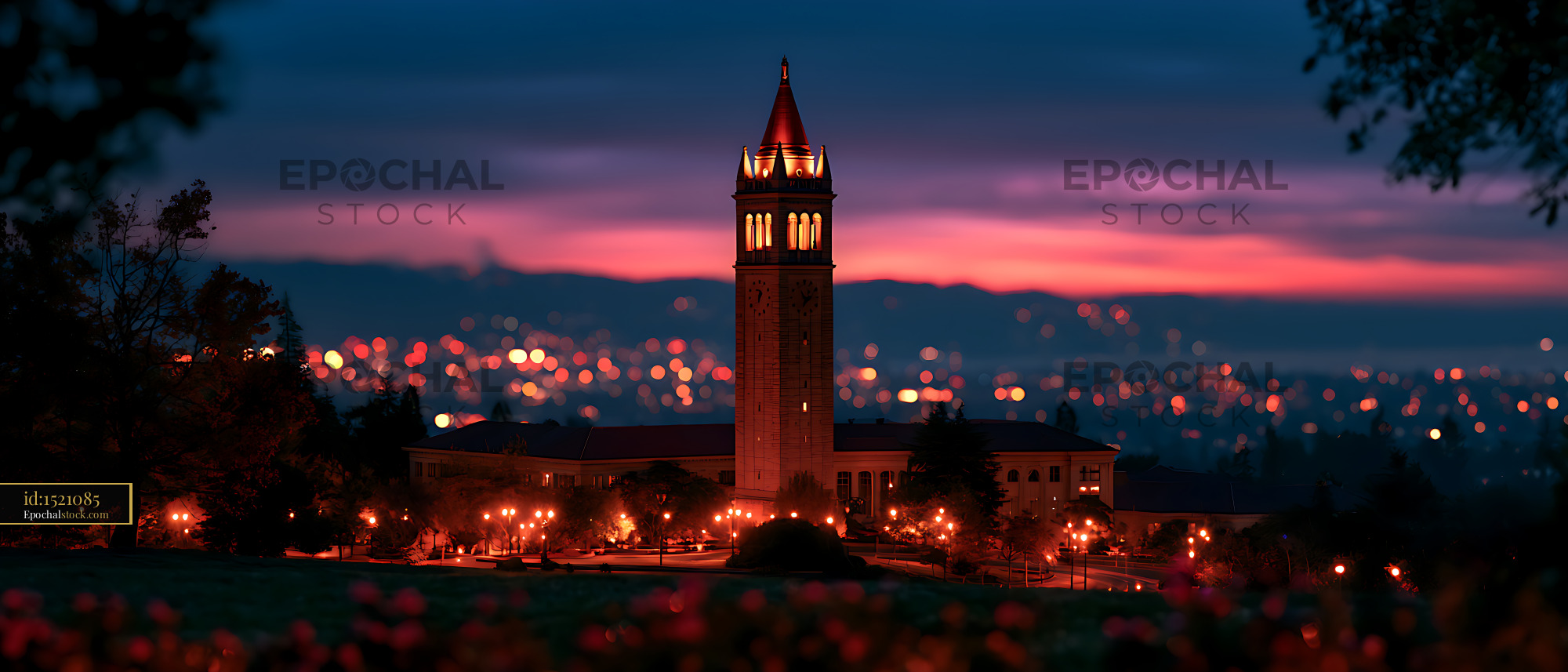 Watermarked full-resolution preview of Historic illuminated tower and campus at colorful dusk