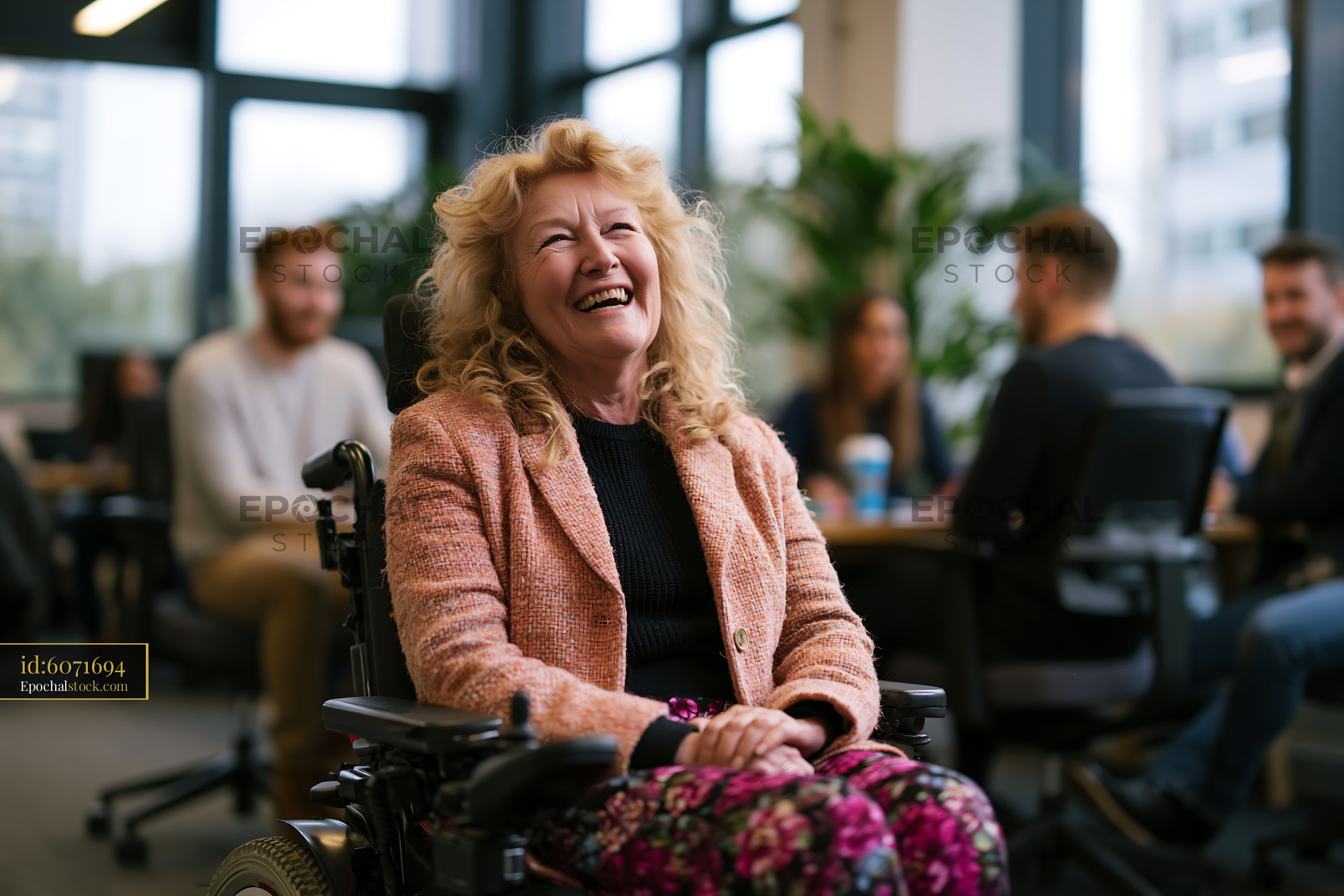 Watermarked full-resolution preview of Laughing woman in wheelchair at an indoor gathering