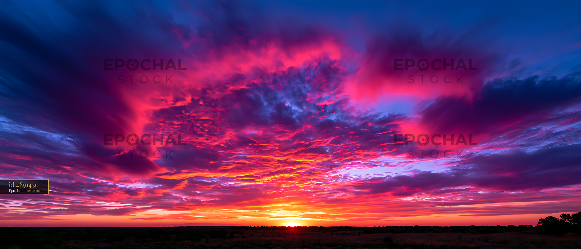Watermarked full-resolution preview of Colorful dramatic sunset clouds above a dark landscape