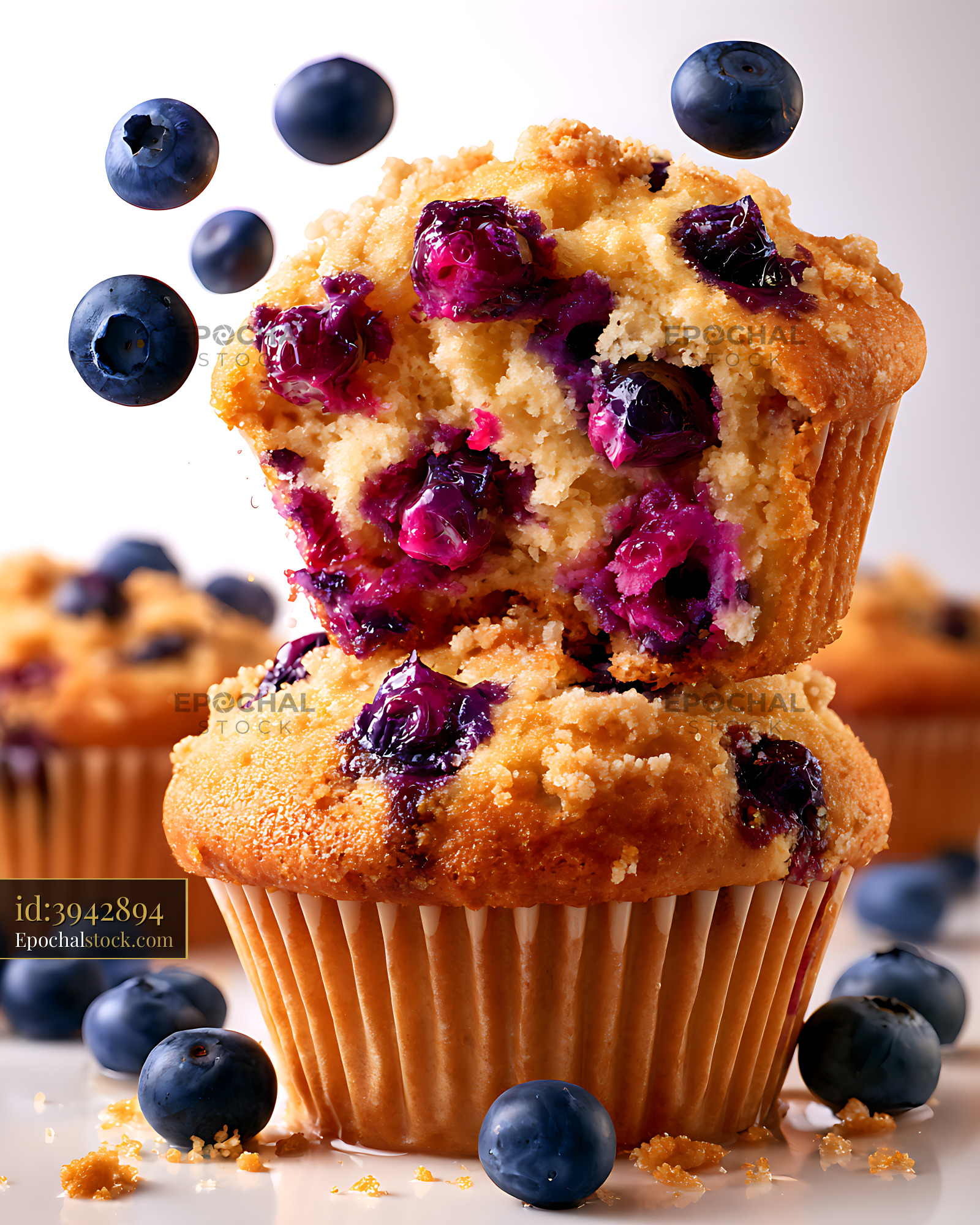 Watermarked full-resolution preview of Blueberry muffins on a white background with fresh blueberries