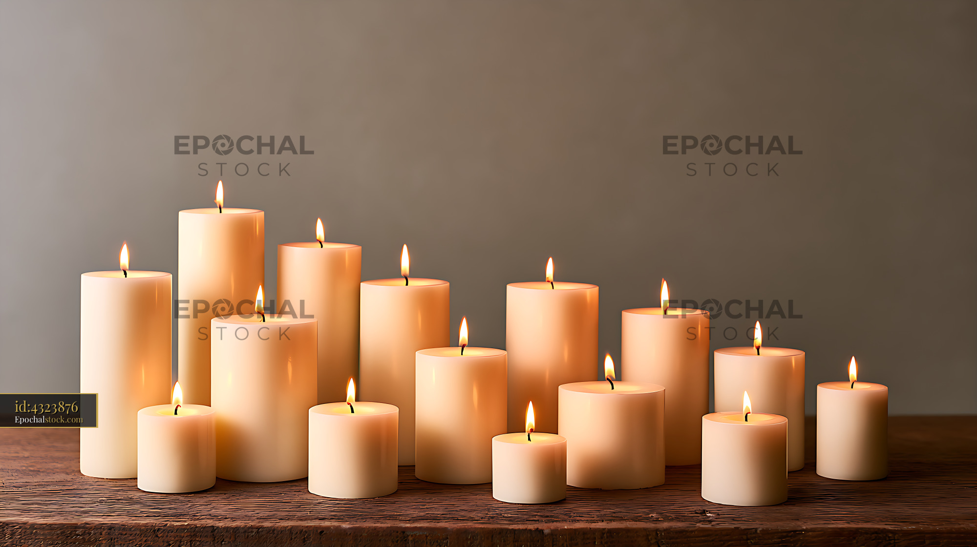 Watermarked full-resolution preview of Warm lit pillar candles arranged on a wooden table