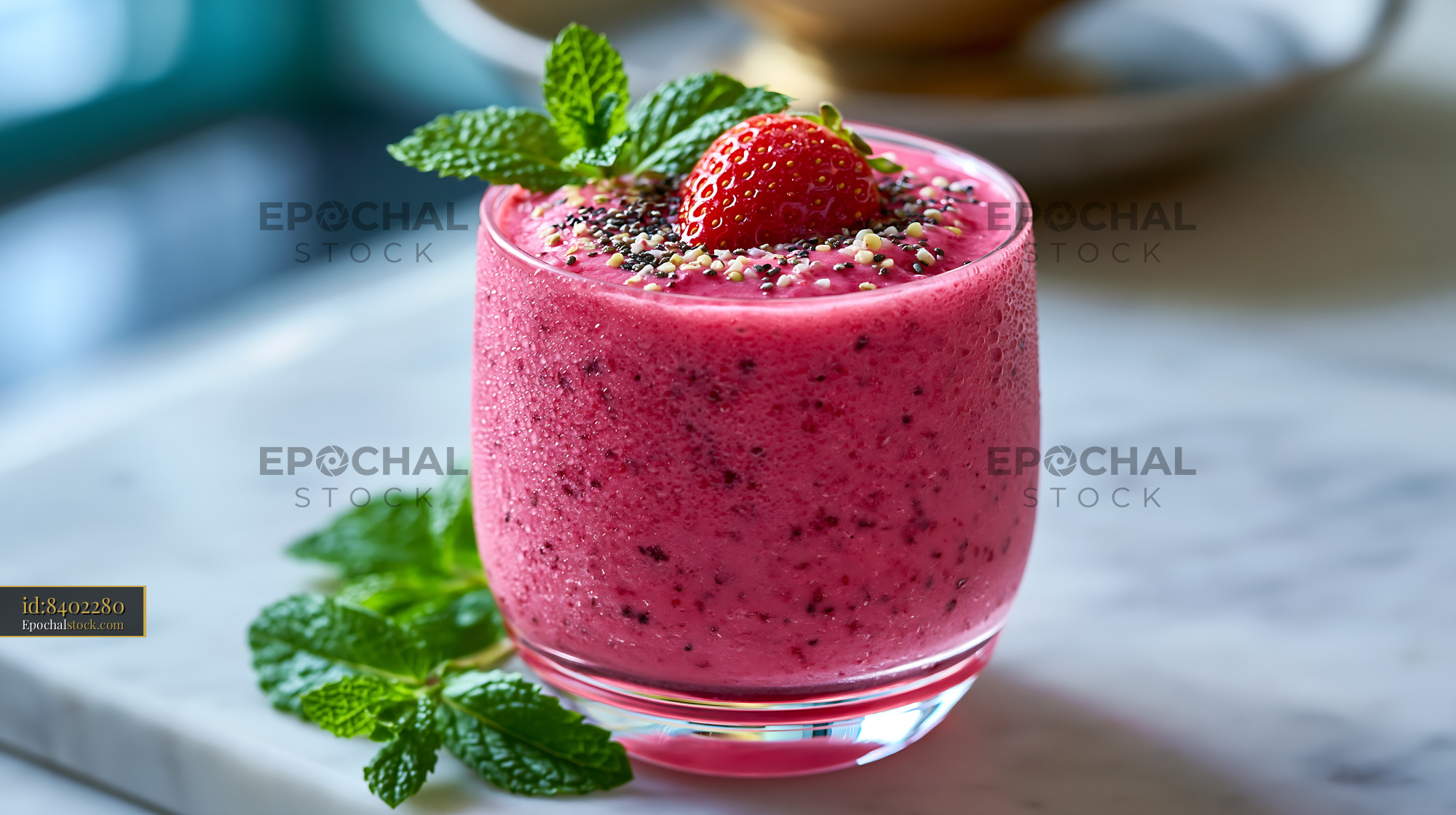 Watermarked full-resolution preview of Strawberry smoothie with mint in a clear glass on a marble table