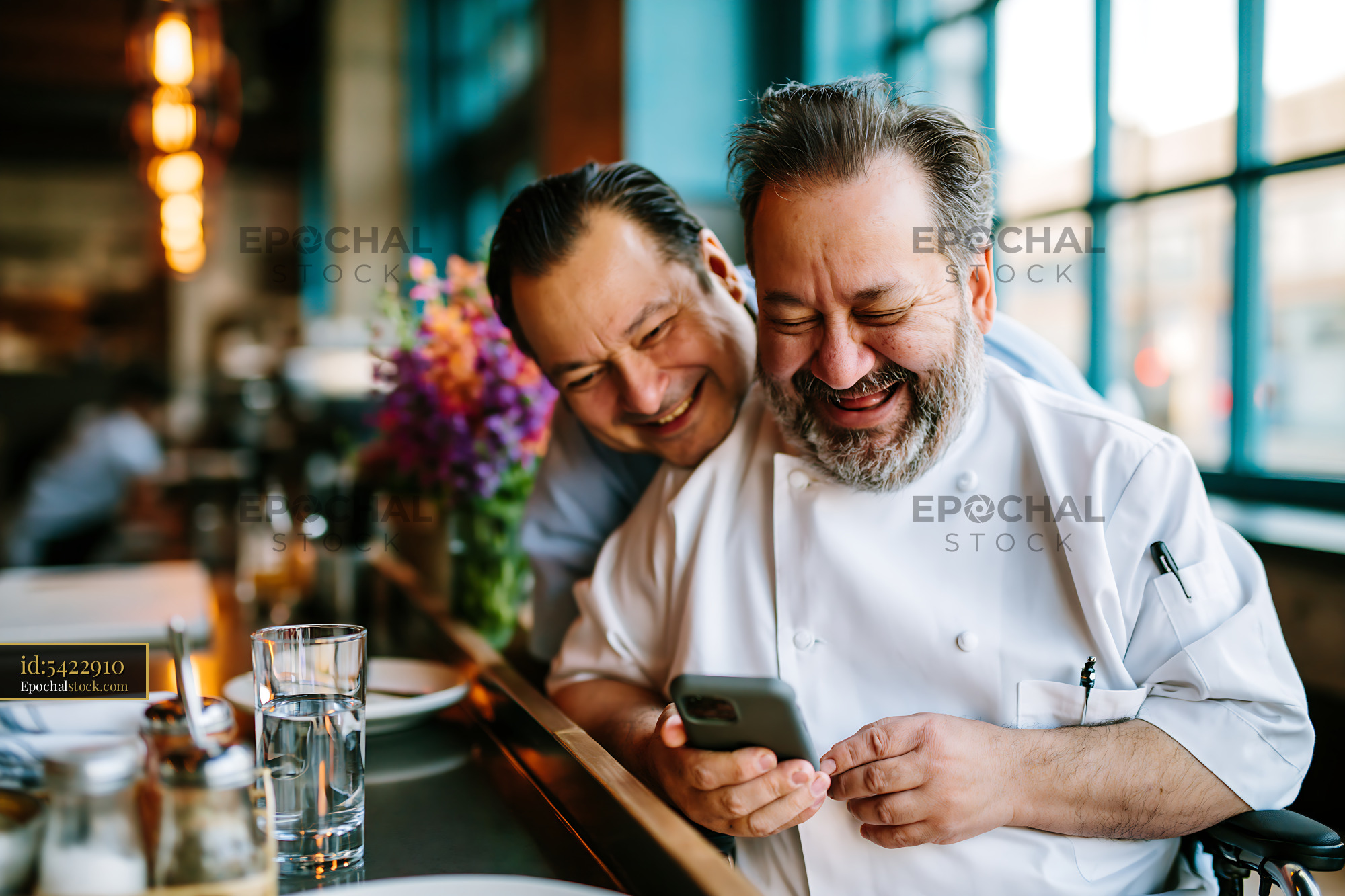 Watermarked full-resolution preview of Two men smiling and enjoying time together in a restaurant