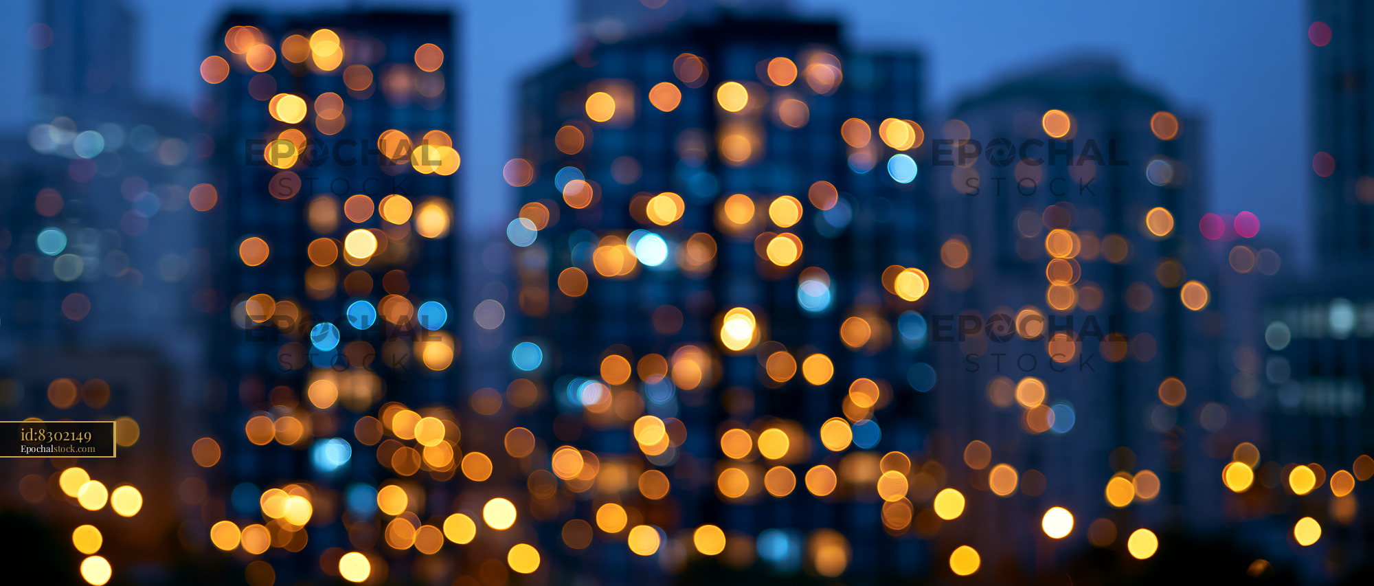 Watermarked full-resolution preview of City skyline with blurred lights at dusk
