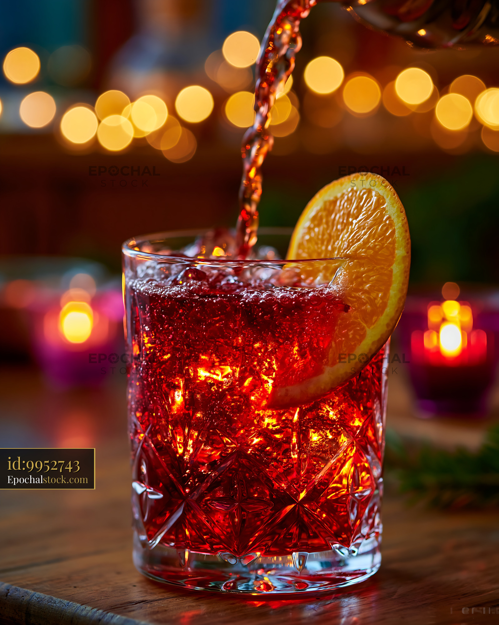 Watermarked full-resolution preview of Pouring a red drink into a glass with an orange slice