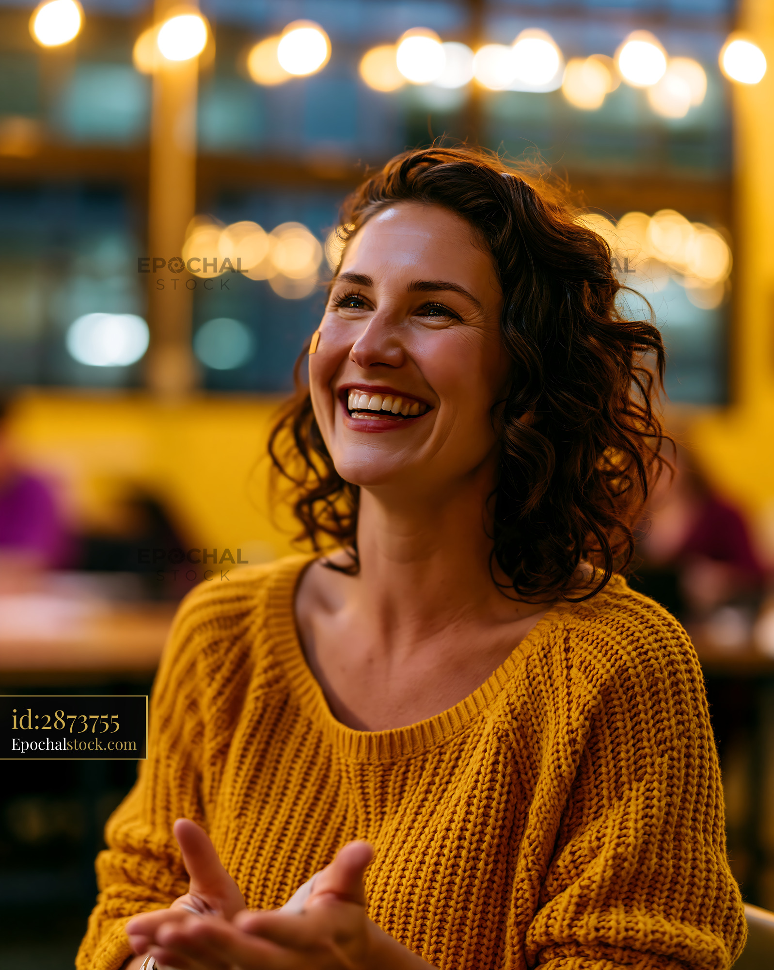 Joyful Teacher Using Sign Language Laughing in Classroom Setting - stock photo