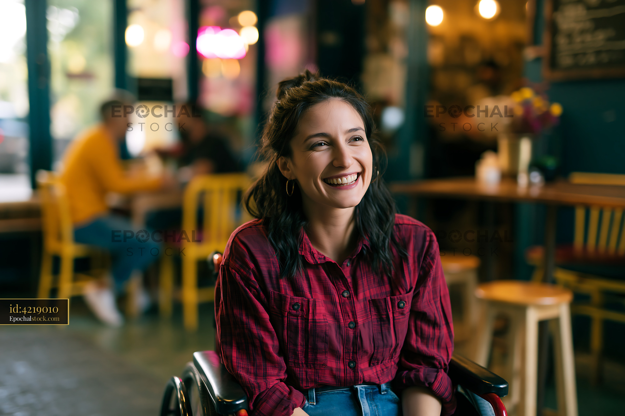 Watermarked full-resolution preview of Smiling woman in a wheelchair at a cafe
