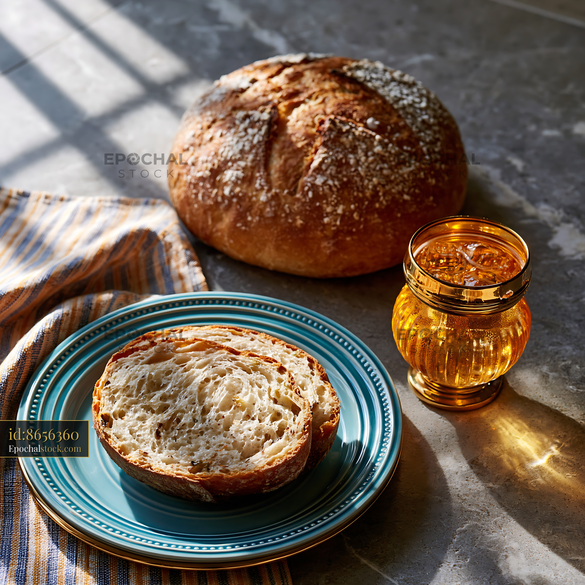 Watermarked full-resolution preview of Fresh bread and tea placed on a marble countertop