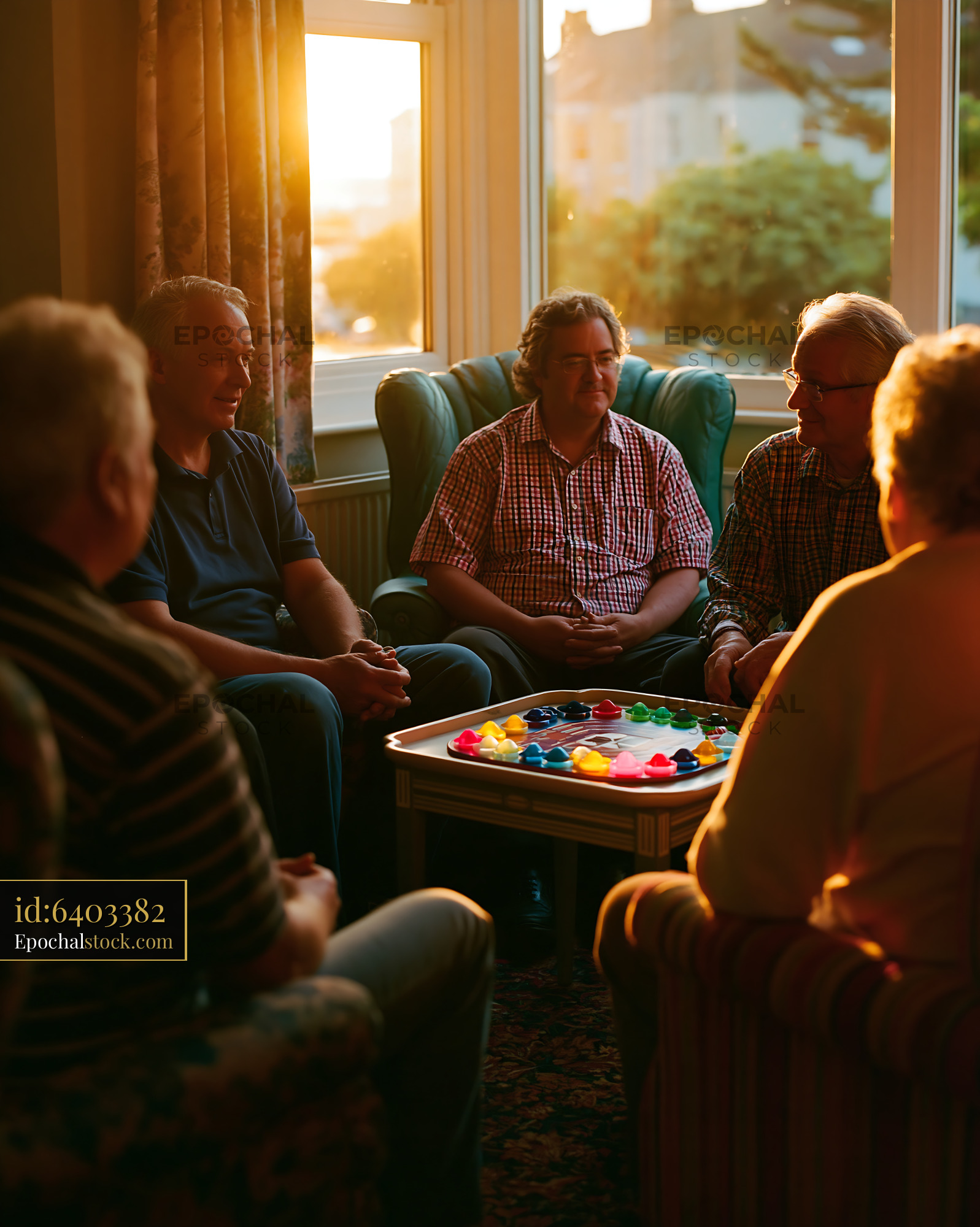 Men's Support Group in Circle Playing Games During Golden Hour - stock photo