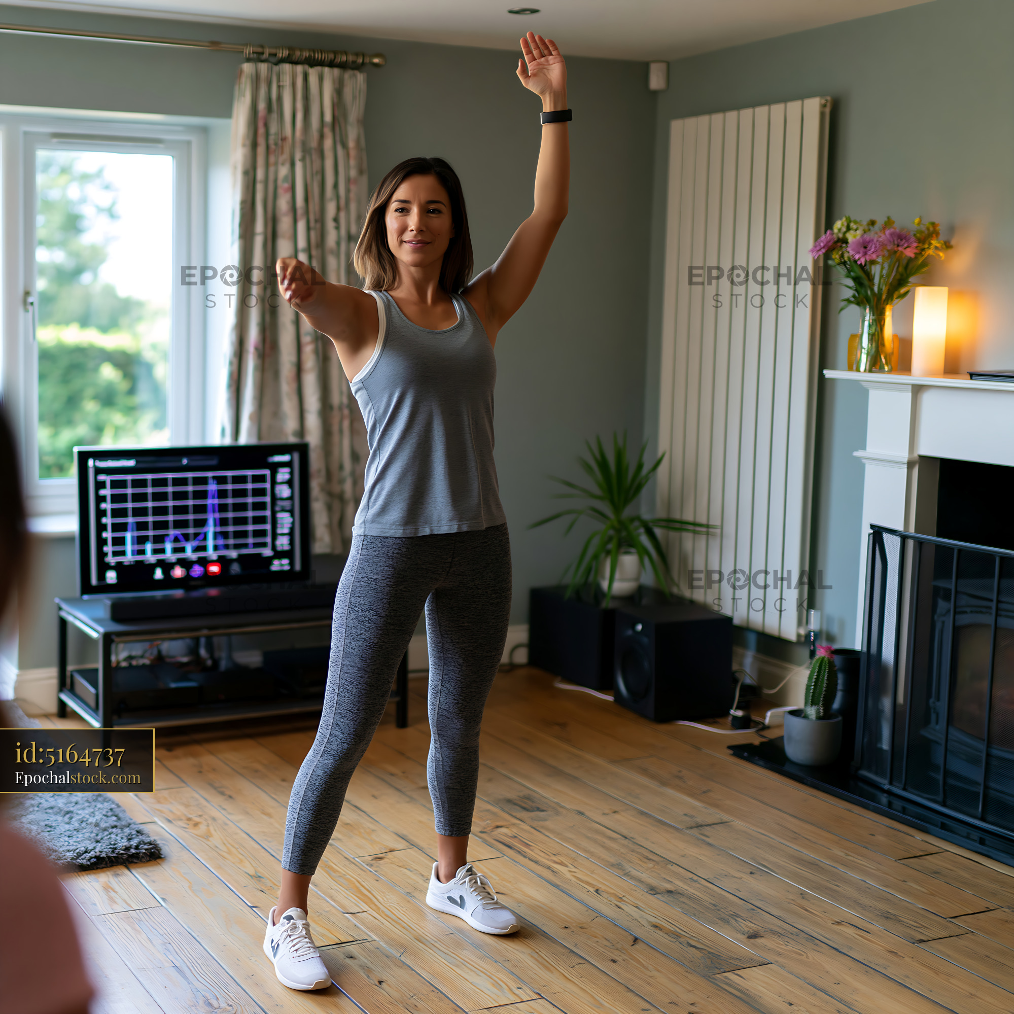 Watermarked full-resolution preview of Woman exercising at home in a living room