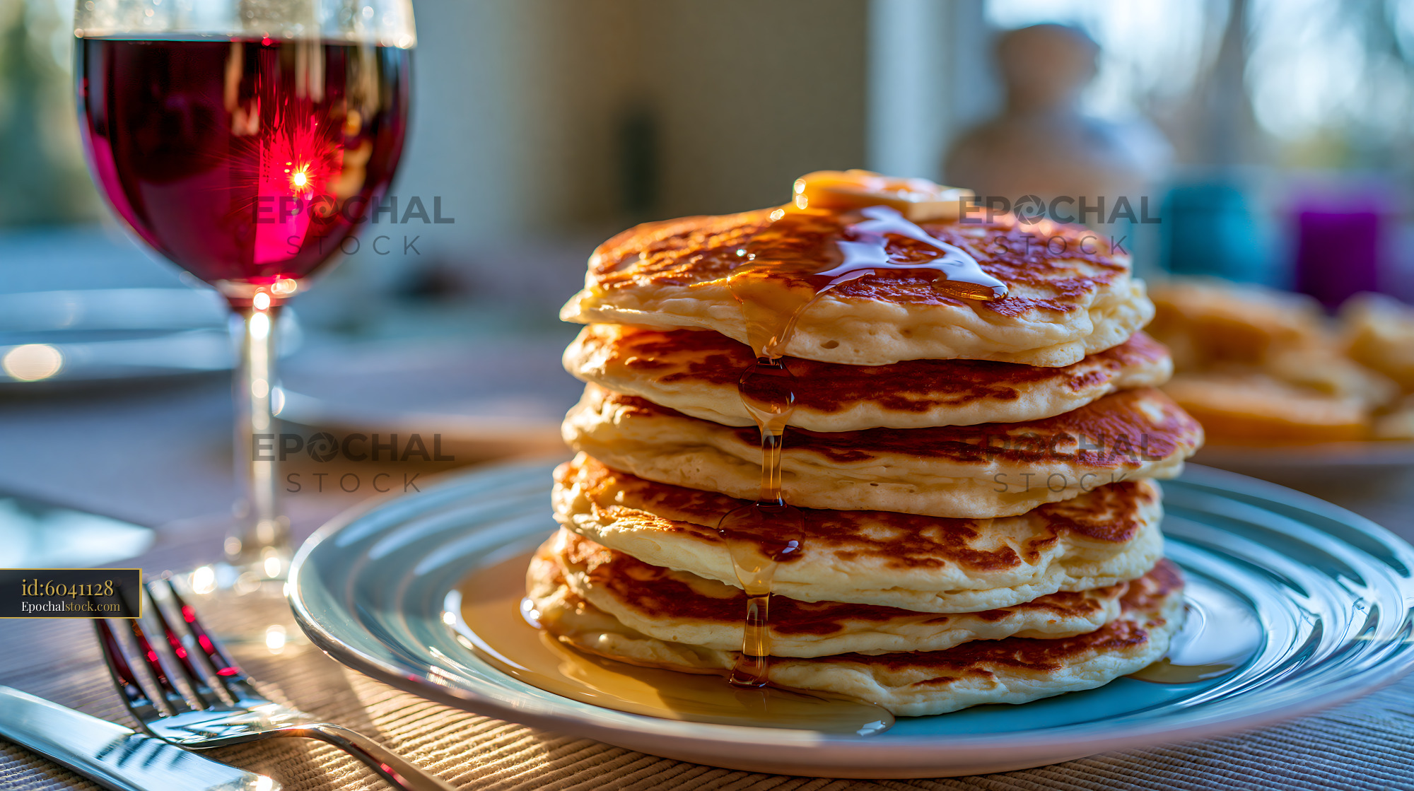 Watermarked full-resolution preview of Stack of pancakes with syrup and a glass of red drink