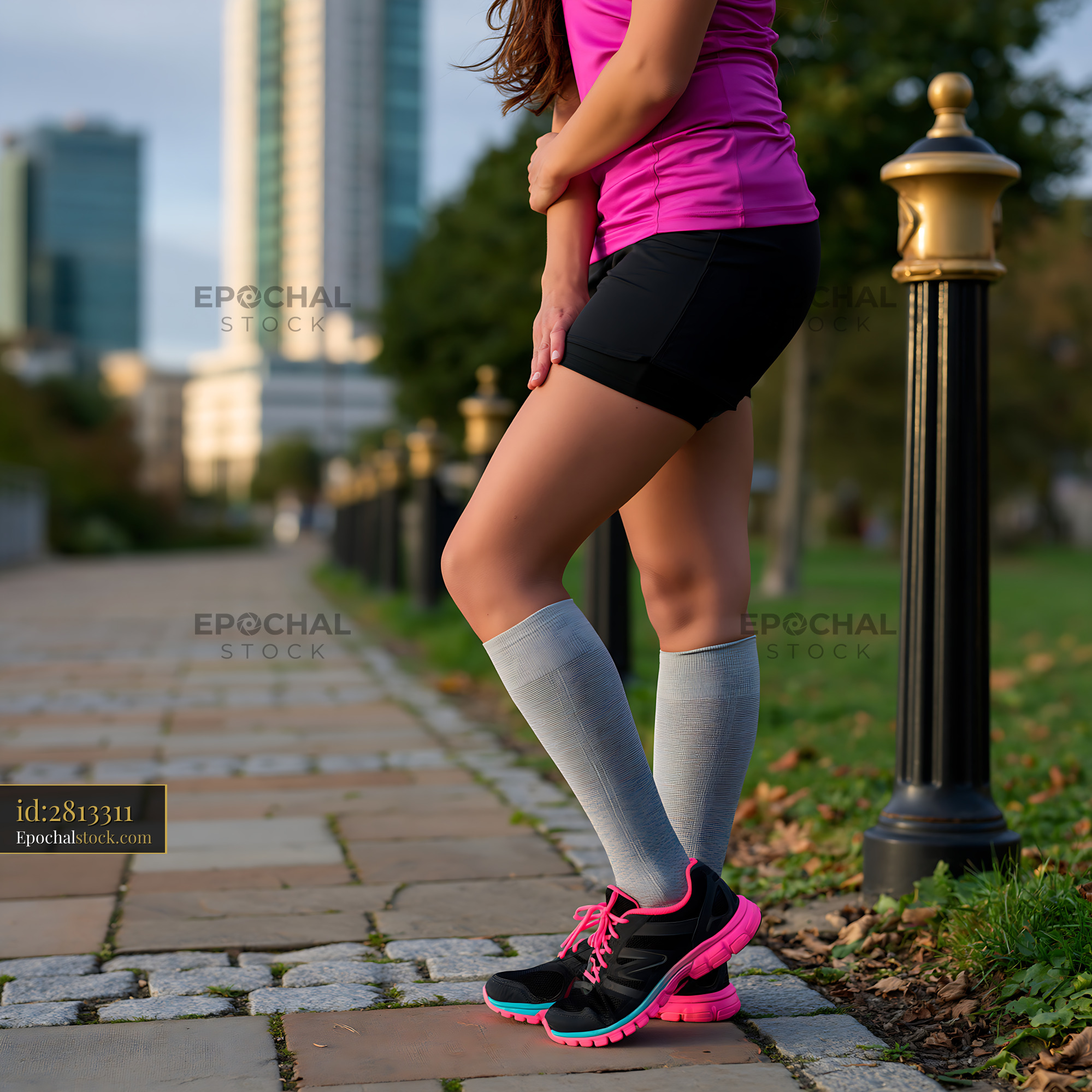 Watermarked full-resolution preview of Woman running on a city path wearing sports attire