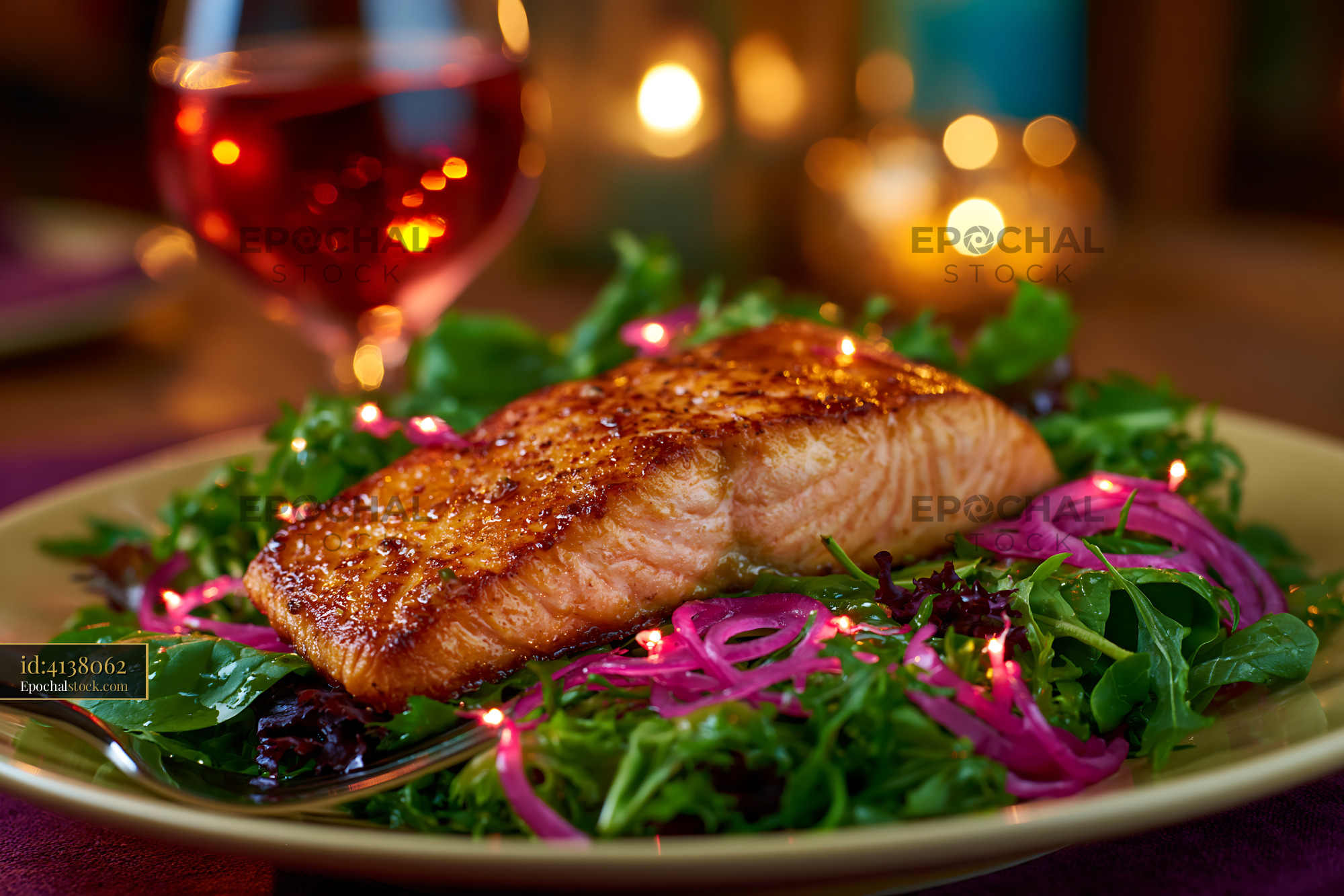 Watermarked full-resolution preview of Freshly cooked salmon served on a bed of greens with pink onions