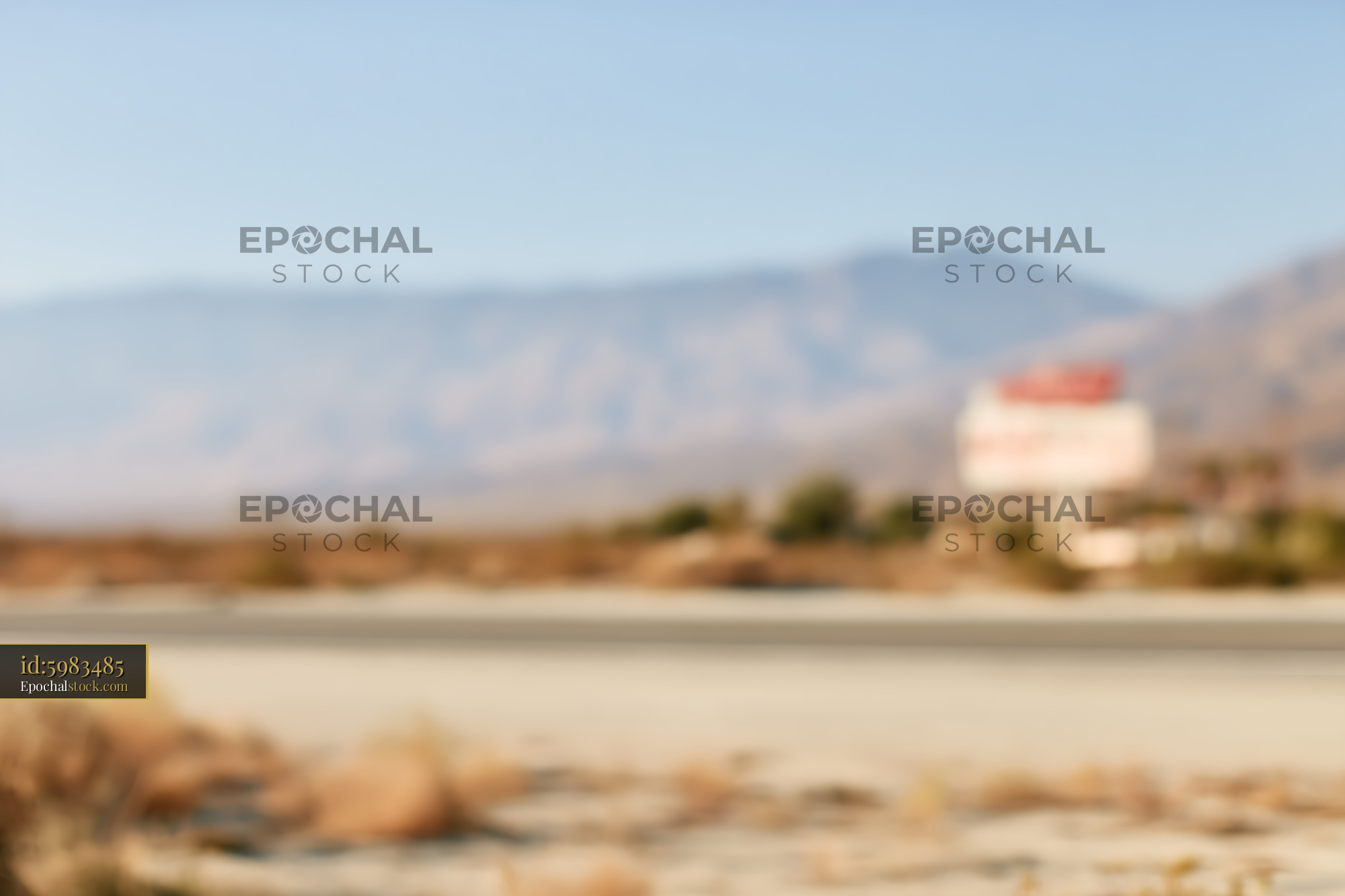 Watermarked full-resolution preview of Soft focus desert road and mountain landscape